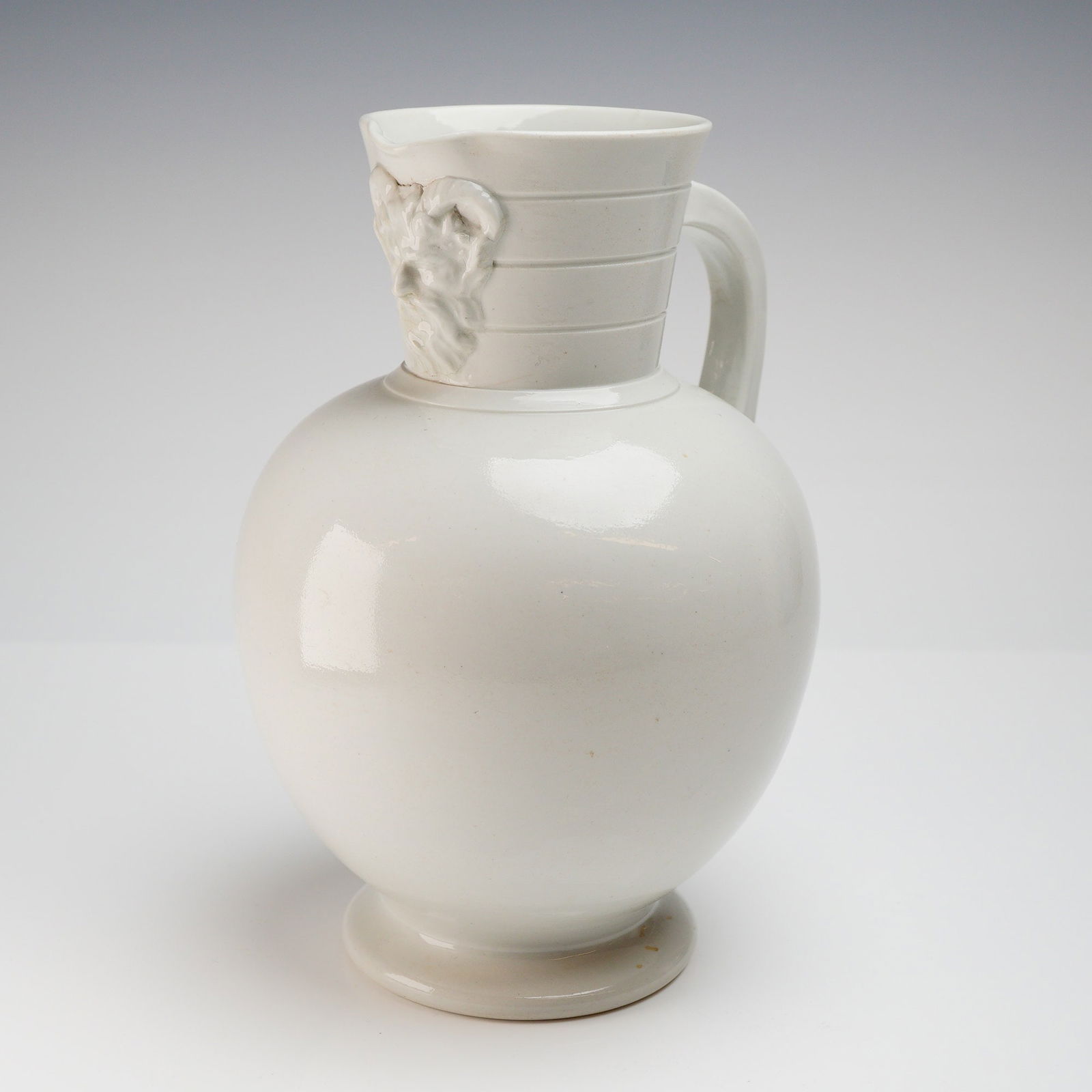 Wedgwood White Majolica Doric Jug: Features the distinctive Doric column motif, characterized by crisp architectural fluting and a strong classical profile. The white majolica glaze highlights the sculptural relief, giving the piece a