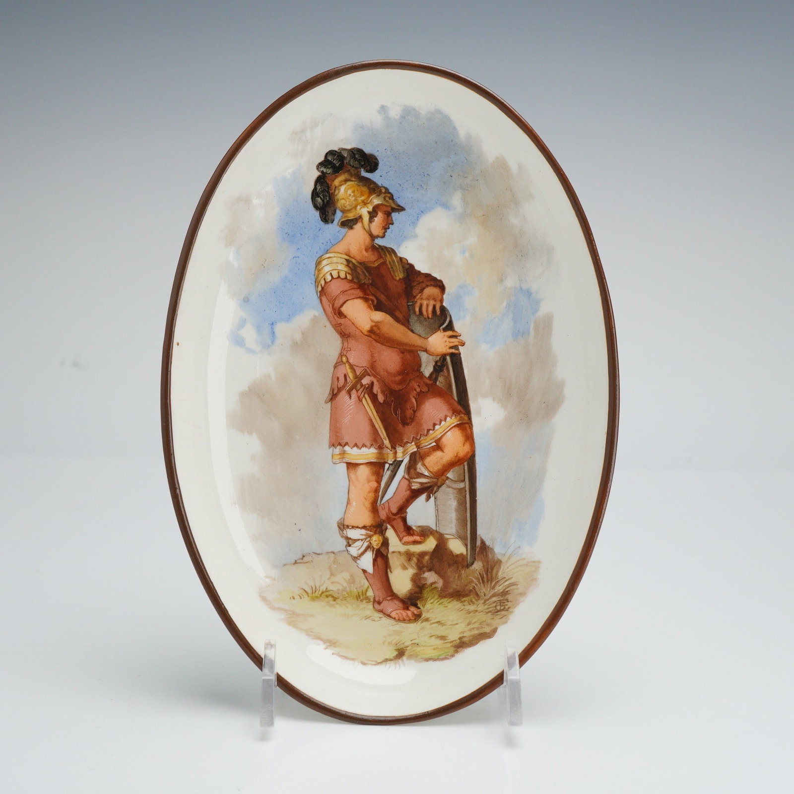 Wedgwood Hackwood Hand-Painted Ceramic Dish, Un Centurion Romain: A fine mid-19th century oval ceramic dish, likely refined stoneware or porcelain, featuring a detailed hand-painted polychrome central scene. The composition depicts a Roman centurion in classical arm