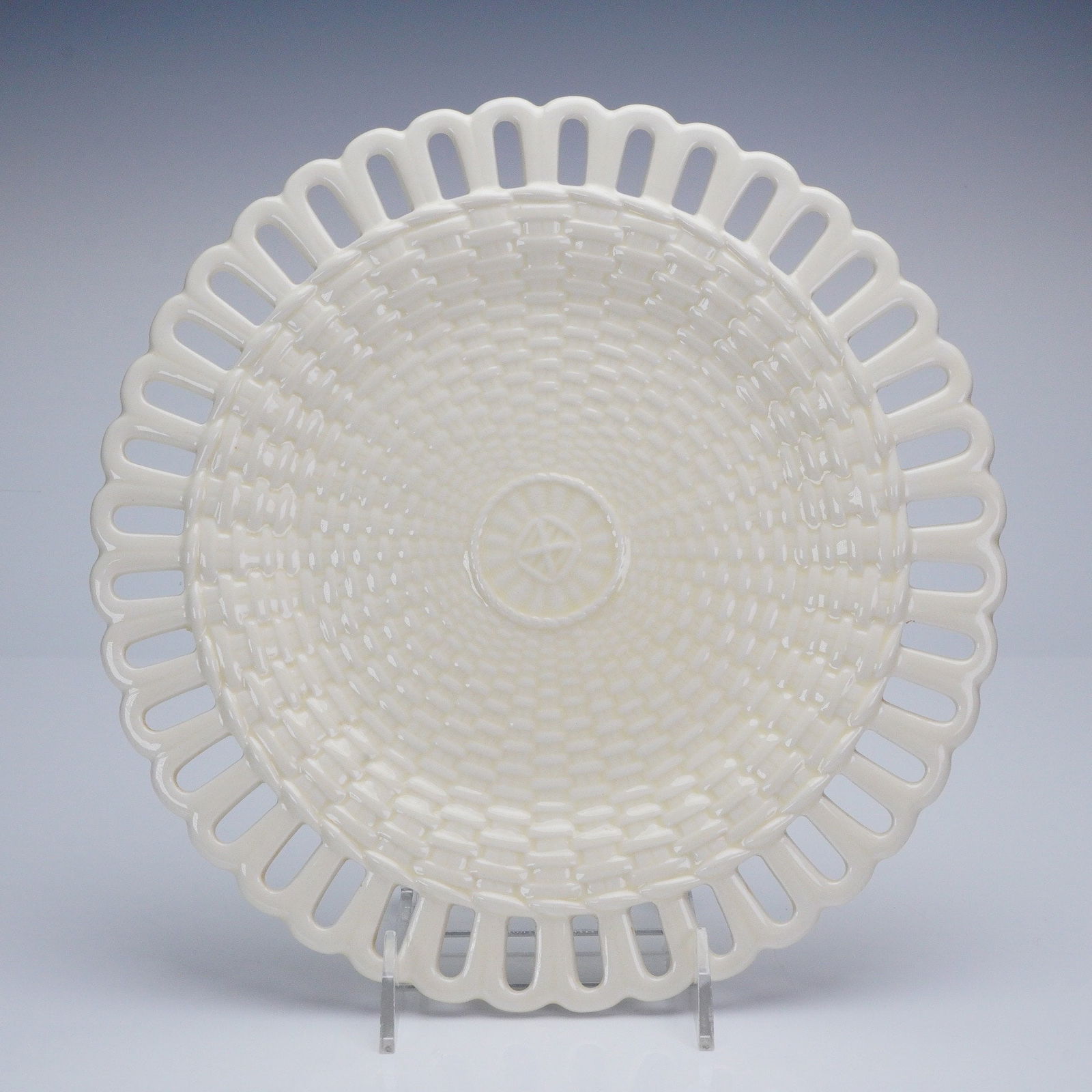Wedgwood of Etruria & Barlaston Basket Weave Reticulated Plate: A circular glazed earthenware Wedgwood plate featuring a uniform cream or pale yellow coloration. The plate displays extensive molded decoration, including a central well patterned in high relief to r