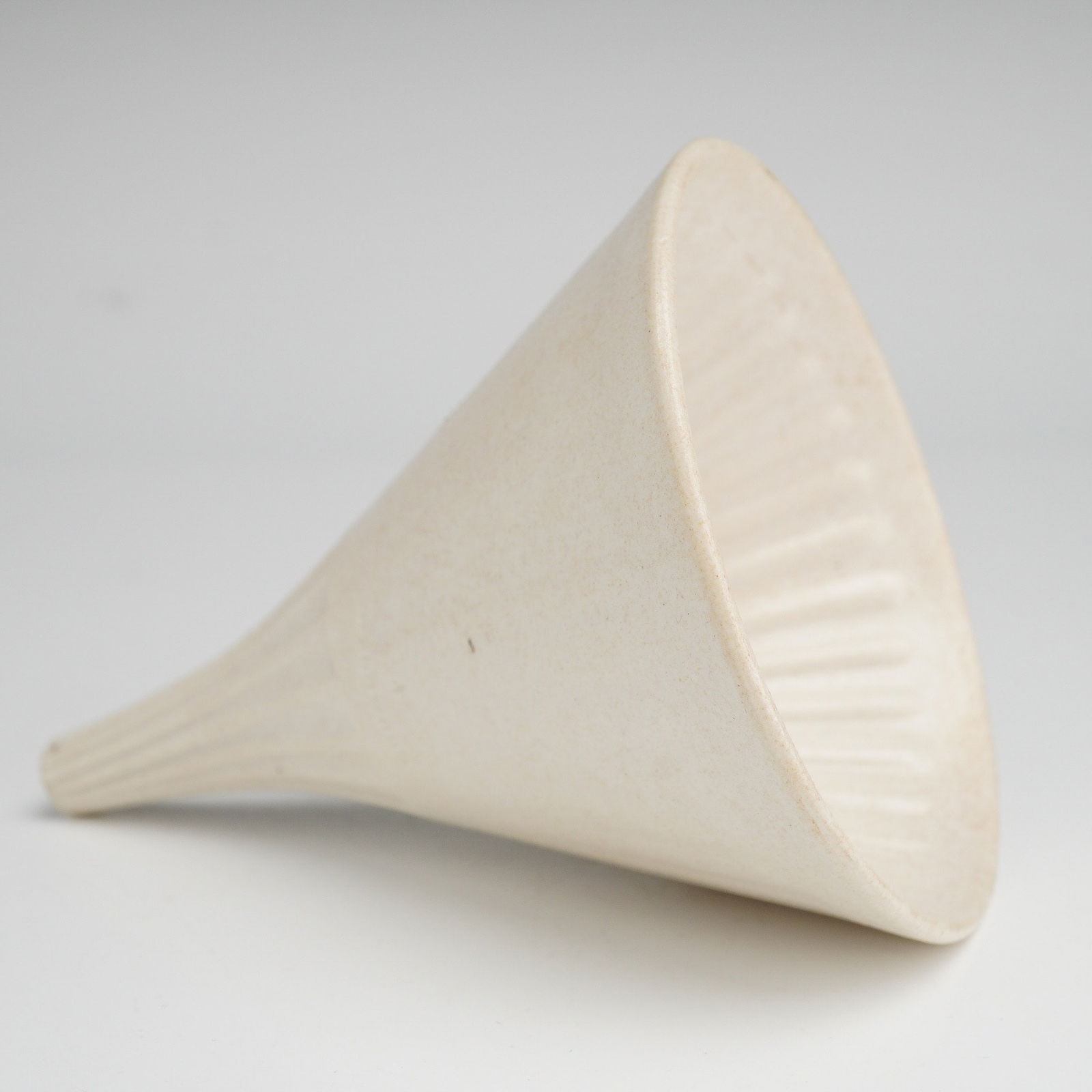 Wedgwood Smear Glazed Stoneware Funnel: A Wedgwood ceramic funnel crafted from cream-colored smear glazed stoneware. The piece features a decorative fluted or ribbed design on the interior of the cone and the exterior of the tapered neck. T