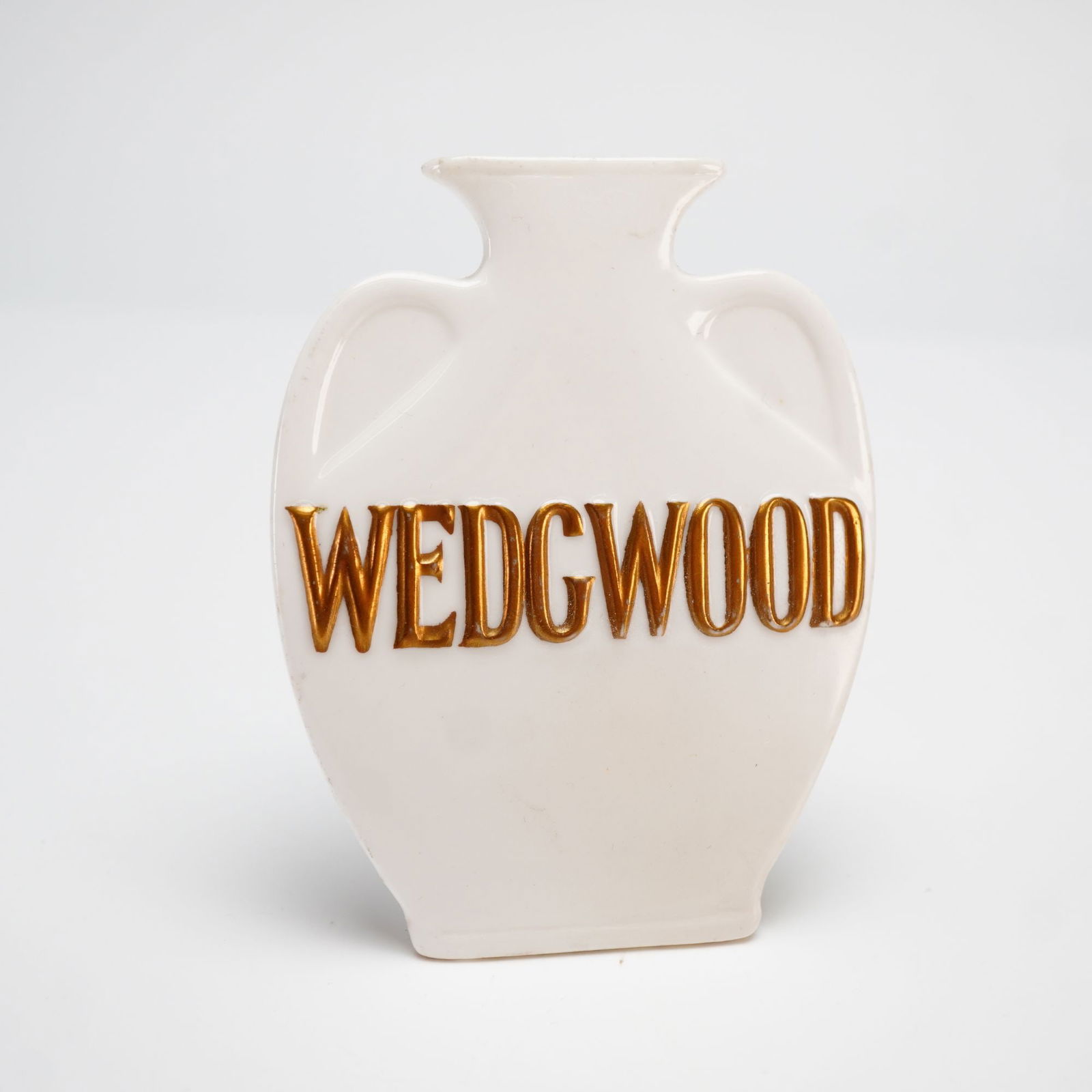 Wedgwood Porcelain Advertising Display Sign: A Wedgwood porcelain advertising display sign or plaque, late 20th century. This dealer display piece is designed in the stylized form of a classical amphora with an integrated easel-back support for