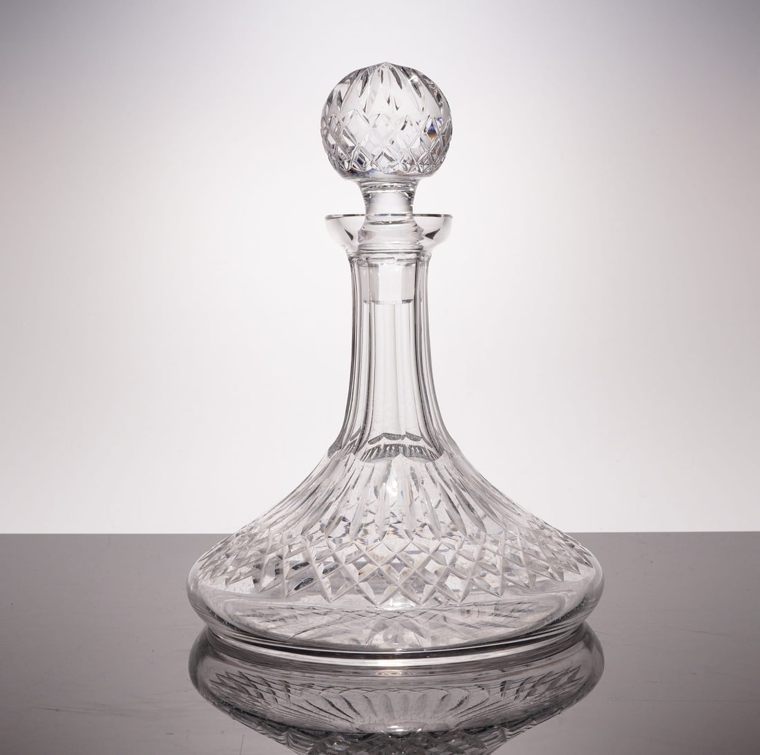 Waterford Crystal Lismore Ships Decanter with Stopper: This is a fine, heavy-cut lead crystal ships decanter featuring the Lismore pattern. The vessel is characterized by a traditional wide, flat base designed for stability. The cutting pattern consists o