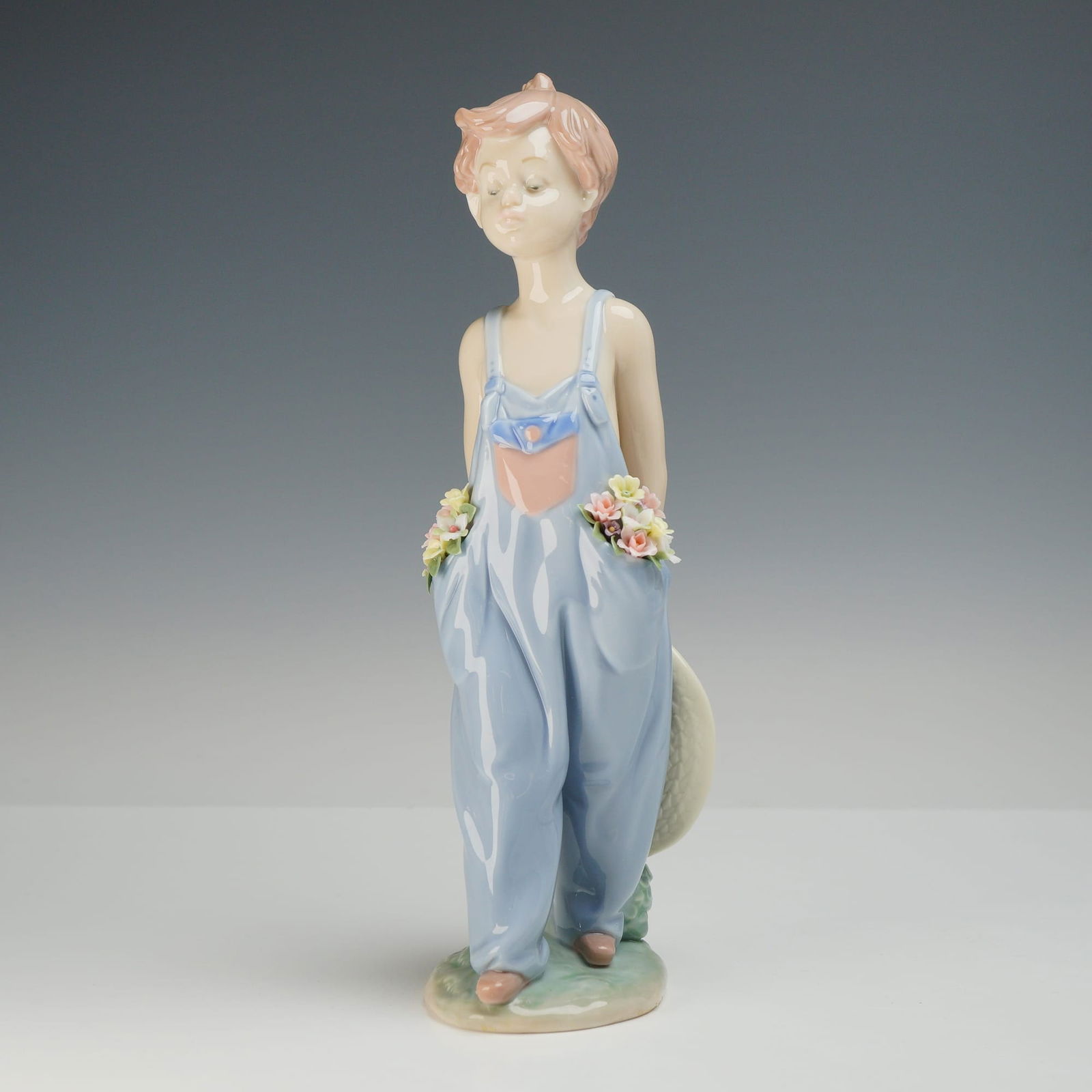 Lladro Pocket Full of Wishes Porcelain Figurine 7650: A glazed porcelain figurine manufactured by Lladro in Spain, titled Pocket Full of Wishes, model number 7650. This piece was produced specifically for the Lladro Collectors Society. The figurine depic