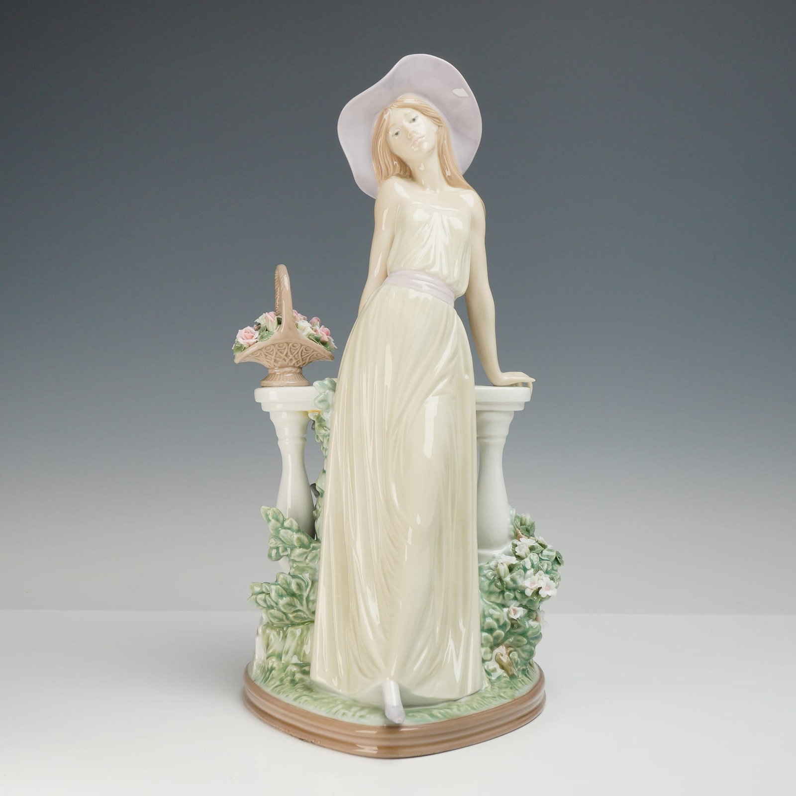 Lladro Time for Reflection Porcelain Figurine 5378: This Lladro porcelain figurine, titled Time for Reflection and designated as model number 5378, depicts a young woman leaning against a classical stone balustrade. The figure is dressed in a floor-len