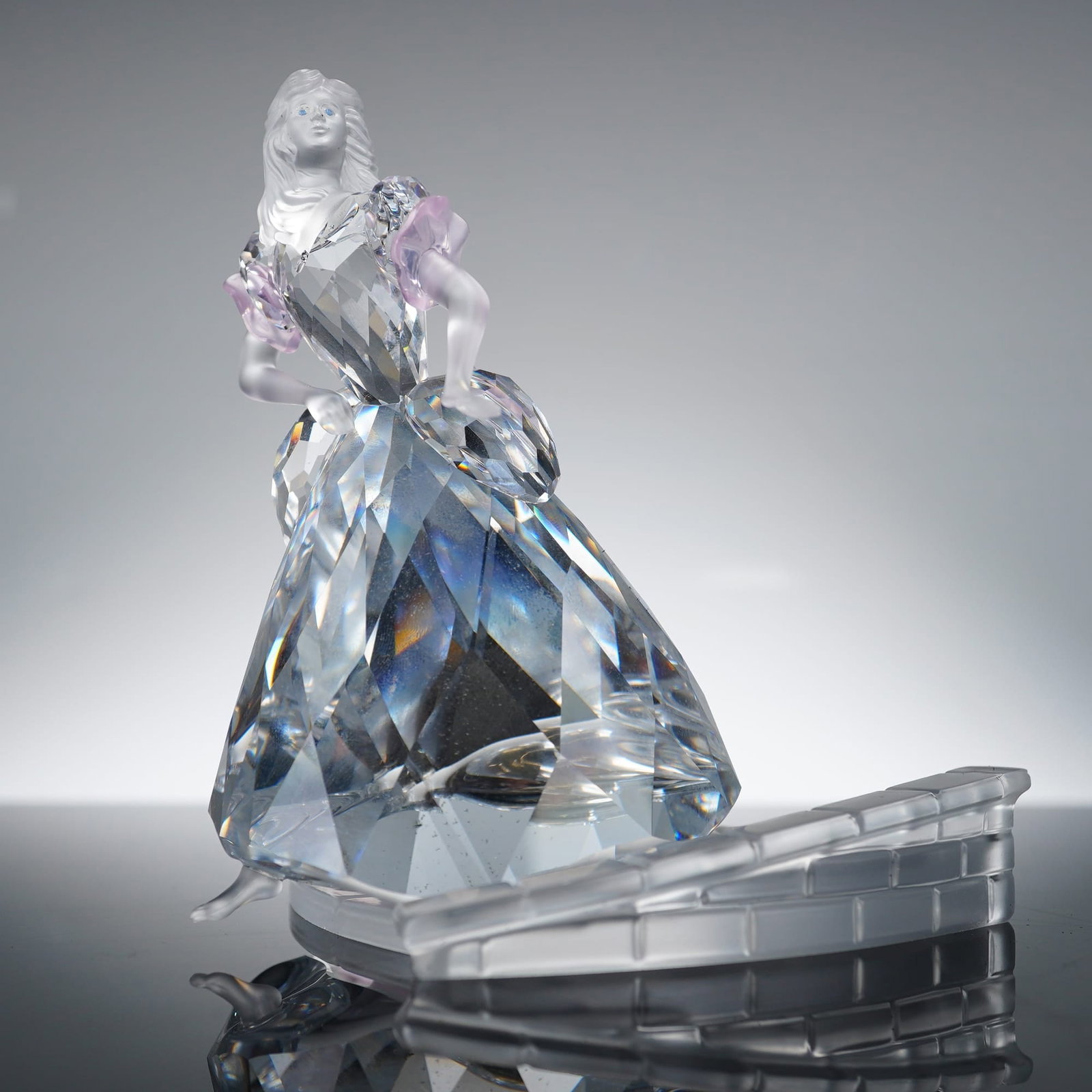 Swarovski Crystal Cinderella Figurine 255108: Swarovski Silver Crystal Cinderella figurine, model number 255108. The figure is constructed from faceted and frosted lead crystal. The head, hair, and arms are crafted in frosted crystal, while the b