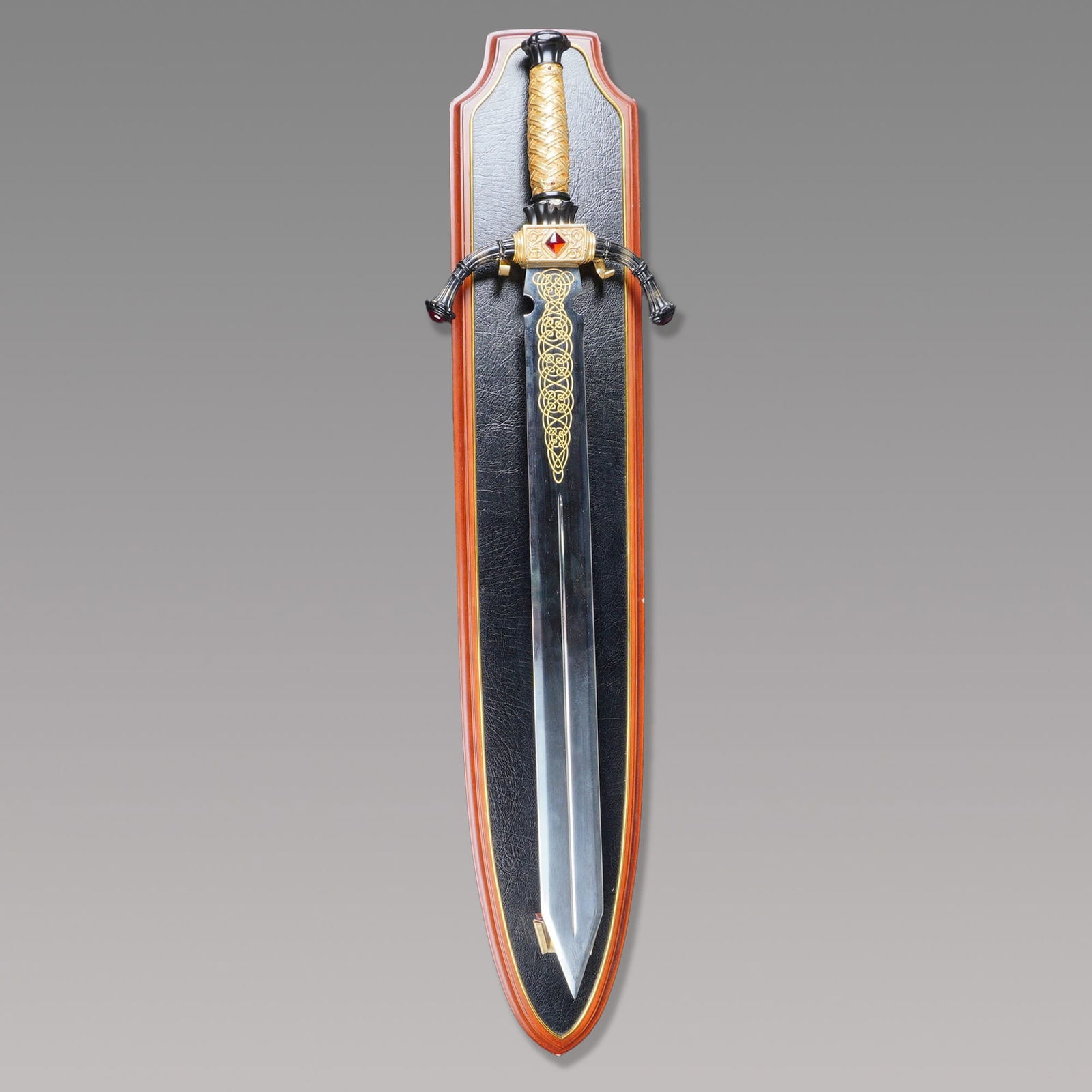 Modern Lord of the Rings Replica Stainless Steel Sword with Wall Plaque: A modern Lord of the Rings replica stainless steel sword produced for decorative display. This civilian fantasy piece features a straight, double-edged polished stainless steel blade characterized by