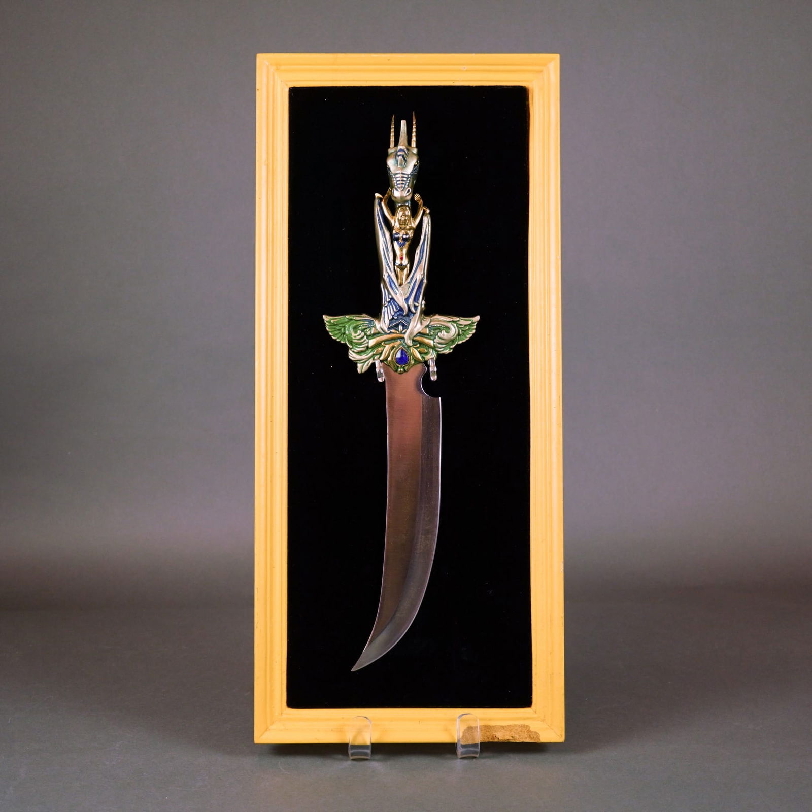 Franklin Mint, Mistress of the Dragon's Realm, Polychrome Enamel Cast Metal: Franklin Mint Mistress of the dragon realm decorative dagger. This fantasy-style fixed-blade knife, designed by artist Julie Bell, features a single stainless steel scimitar-style blade with a notched
