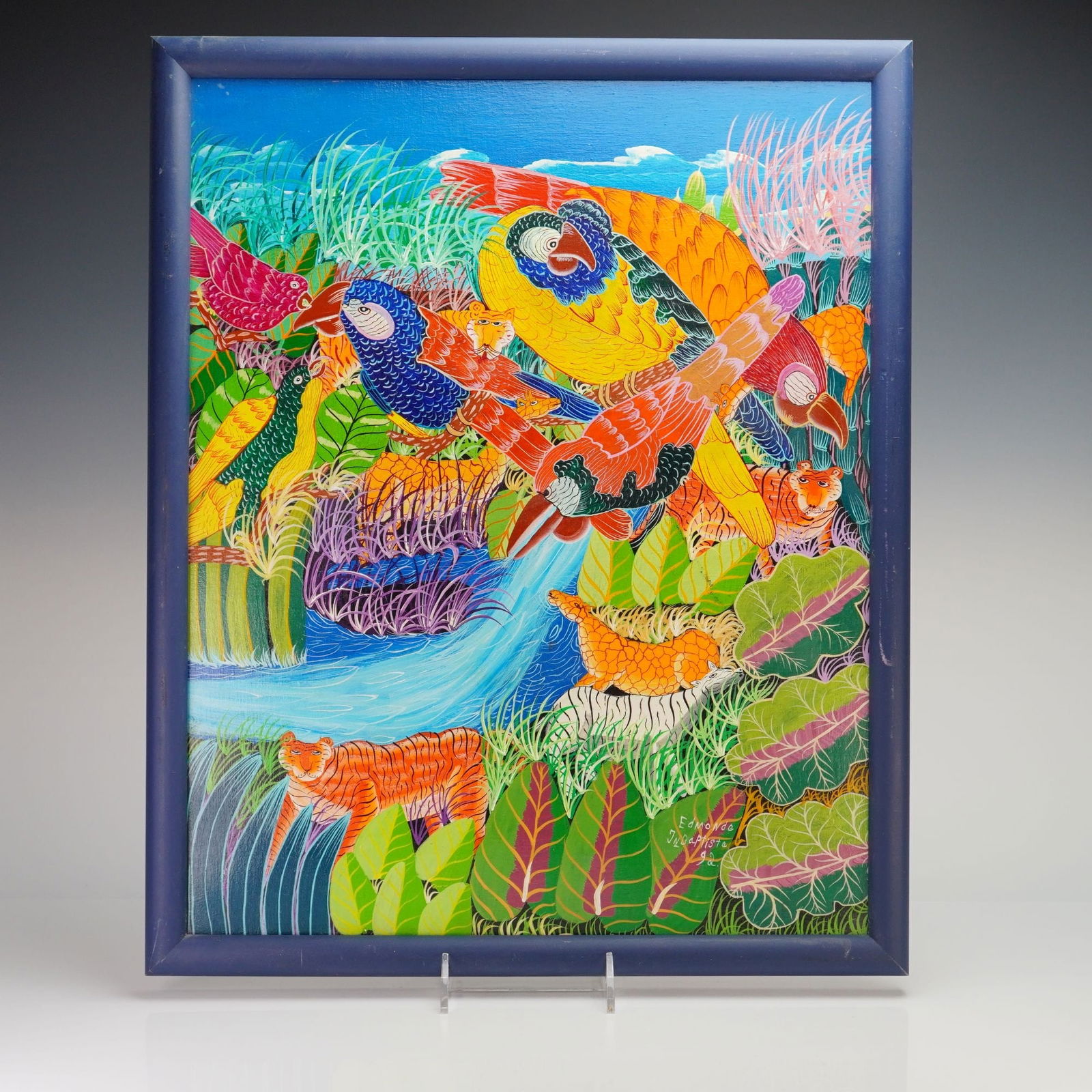 Edmonde Jean-Baptiste (Haitian, 20th Century), Jungle Scene with Macaws and Tigers, 1992 (Signed): Edmonde Jean-Baptiste (Haitian, 20th Century). Oil on stretched canvas. This vibrant jungle scene is a quintessential example of Haitian folk art, featuring a densely layered tropical landscape teemin