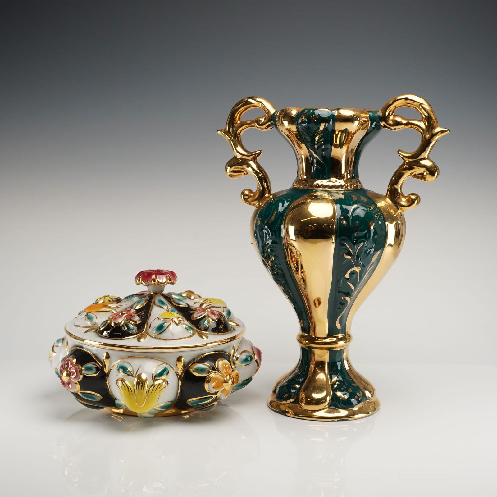 A Pair of Italian Gilt and Polychrome Ceramic Decorative Wares: A two-piece lot of Italian decorative ceramic wares executed in the Baroque Revival style, featuring extensive gilt luster and polychrome enamel detailing. The lot includes an amphora-style vase and a