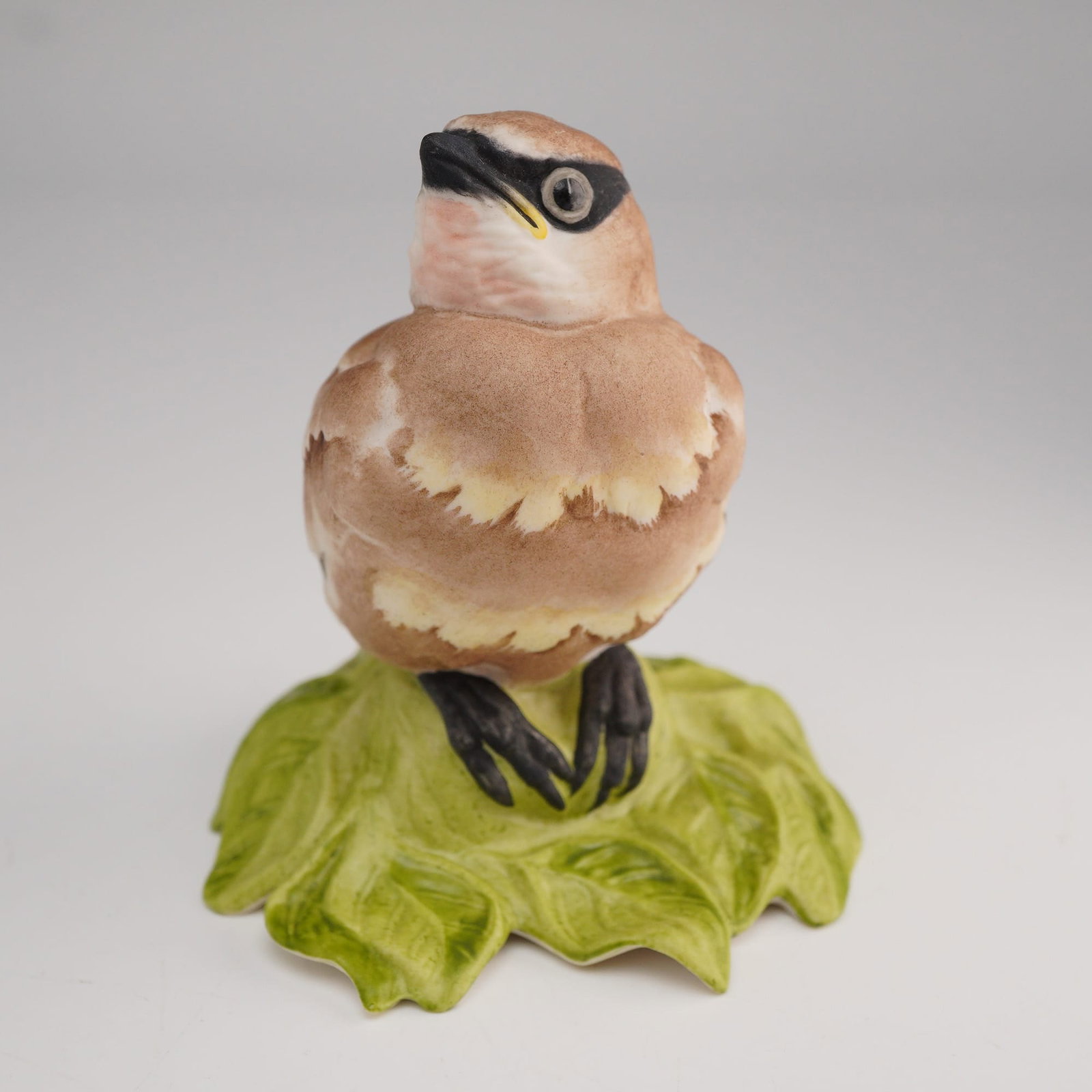 Boehm, Baby Cedar Waxwing Figurine #432: This vintage porcelain figurine is part of the Fledgling Collection by Edward Marshall Boehm. The piece, model 432, depicts a Baby Cedar Waxwing hand-painted in bisque porcelain with characteristic ma