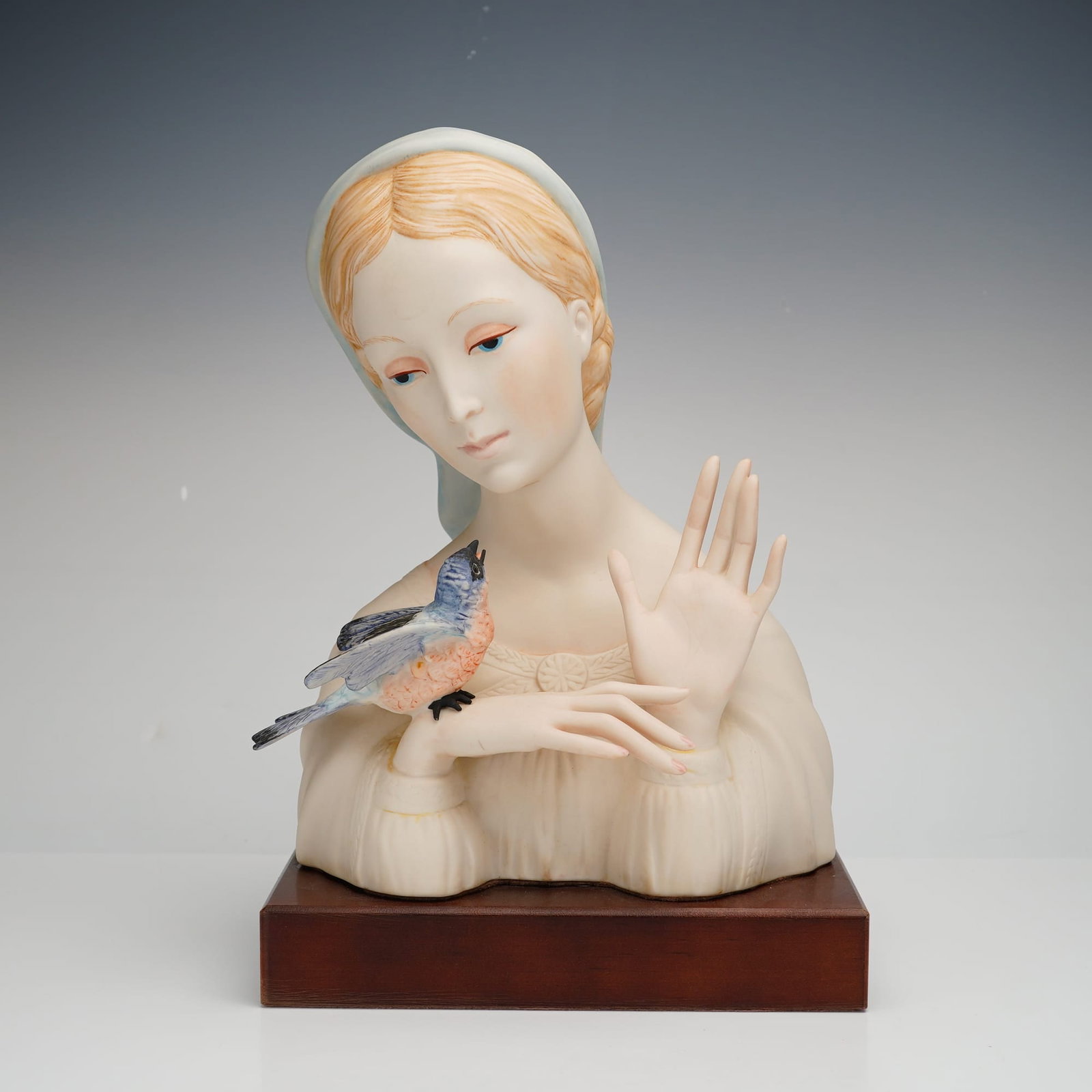 Cybis Madonna with Bird Porcelain Bust: Produced by the Cybis Porcelain Studio of Trenton, New Jersey, this hand-painted bisque porcelain bust is titled Madonna with Bird. Part of the studio's Biblical Collection, the piece depicts a serene