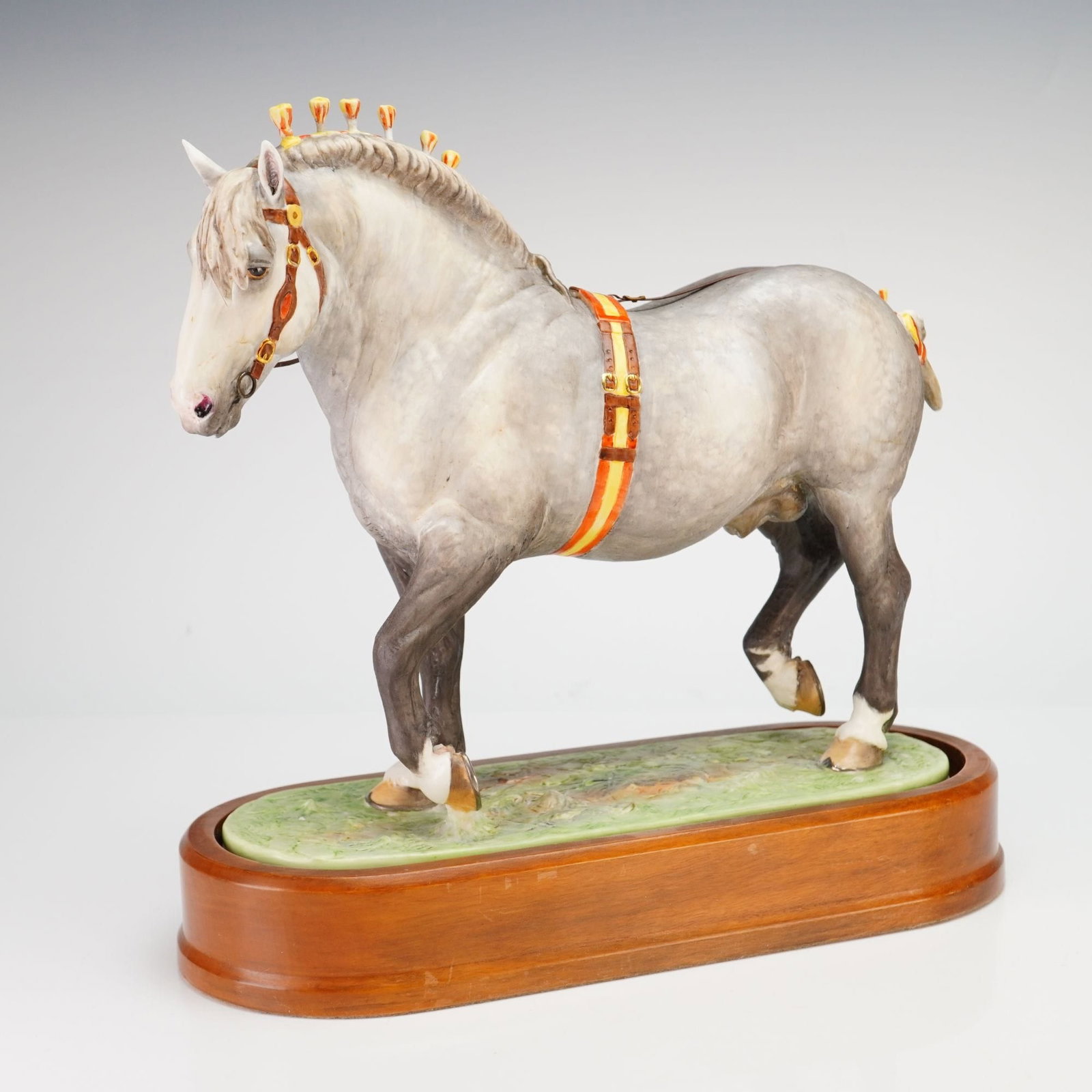 Royal Worcester Percheron Stallion Porcelain Figurine: A Royal Worcester fine bone china figurine of a Percheron Stallion, modeled by the renowned equine artist Doris Lindner. The horse is finished in a matte dappled gray with hand-painted details, depict