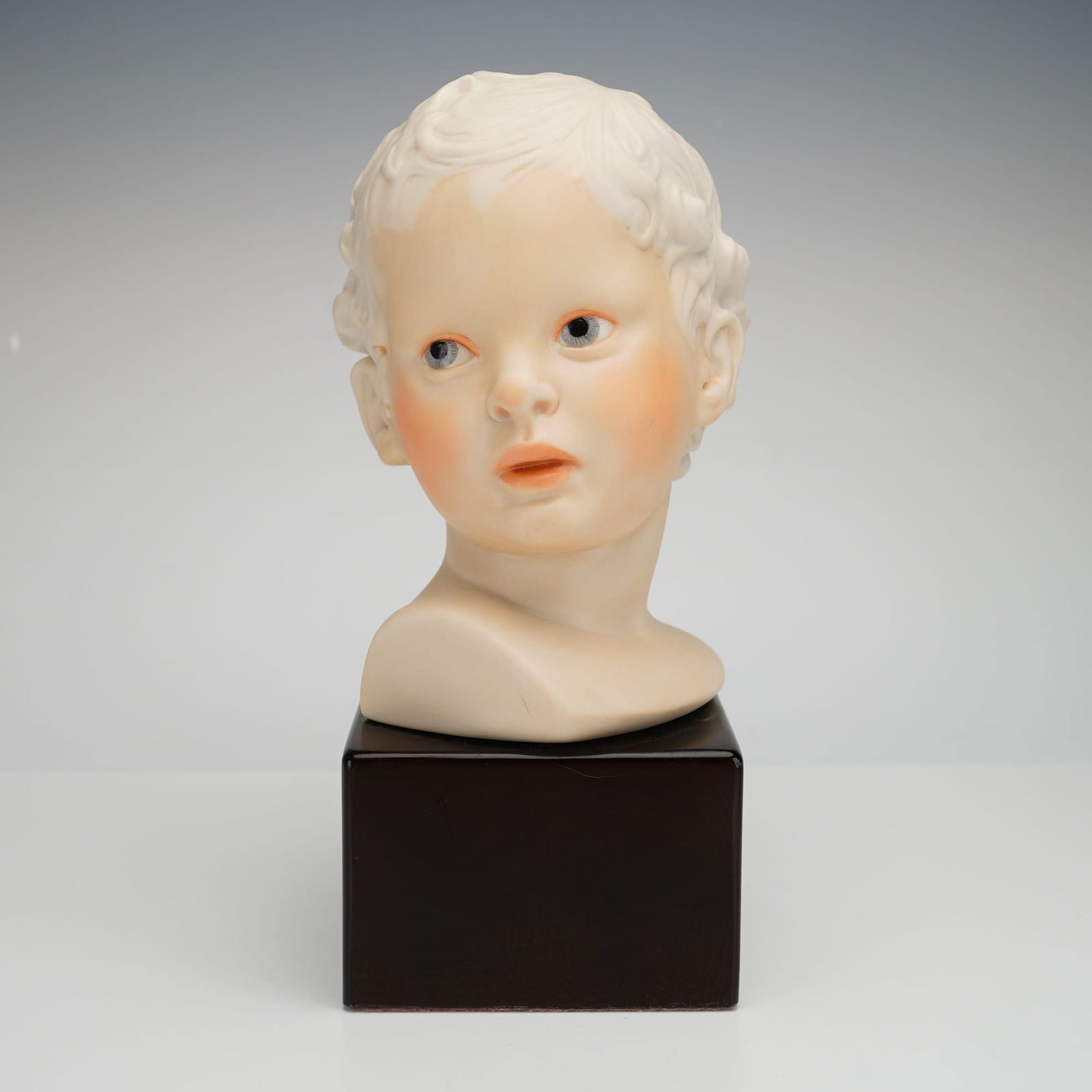 Cybis Porcelain Bust of Eros: A professional-grade bisque porcelain bust of Eros, the Greek God of Love, produced by the renowned American art porcelain studio, Cybis. This finely detailed sculpture depicts Eros as a young boy wit