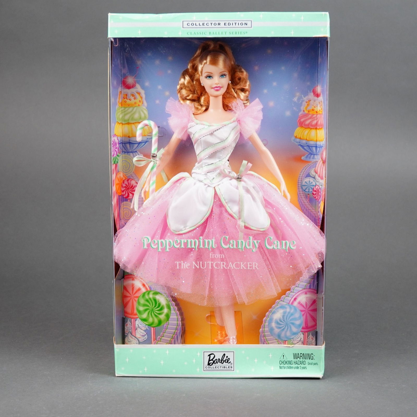 Mattel Barbie as Peppermint Candy Cane from The Nutcracker, 11.5 Inches: Produced by Mattel under the Barbie Collectibles line as part of the Classic Ballet Series, this vinyl collector doll depicts Barbie as Peppermint Candy Cane from The Nutcracker. The doll features roo