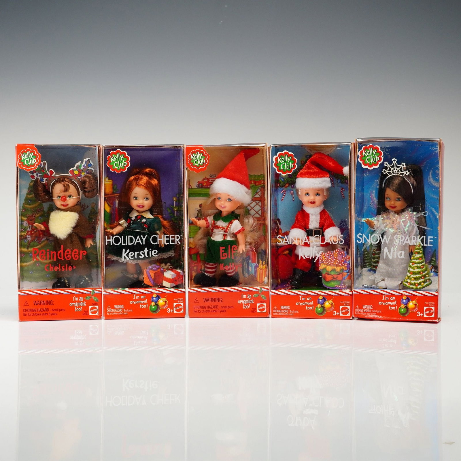 Mattel Barbie Kelly Club Holiday Collection Dolls, 4 inches: A collection of five Mattel Barbie Kelly Club holiday-themed dolls. These vinyl dolls feature rooted hair and fixed, painted eyes. The set includes Reindeer Chelsie, dressed in a brown plush reindeer