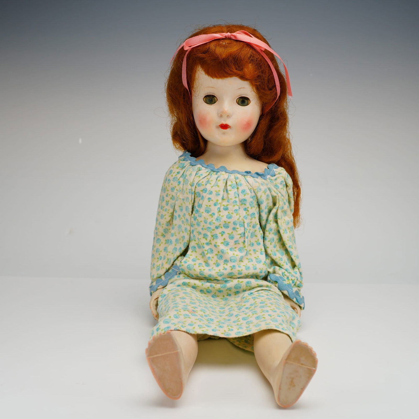 American Character Sweet Sue Walker Doll: This vintage Sweet Sue doll, manufactured by American Character, is a walker model constructed of hard plastic. The doll features a long, wavy red wig, likely mohair or synthetic, styled with a pink r