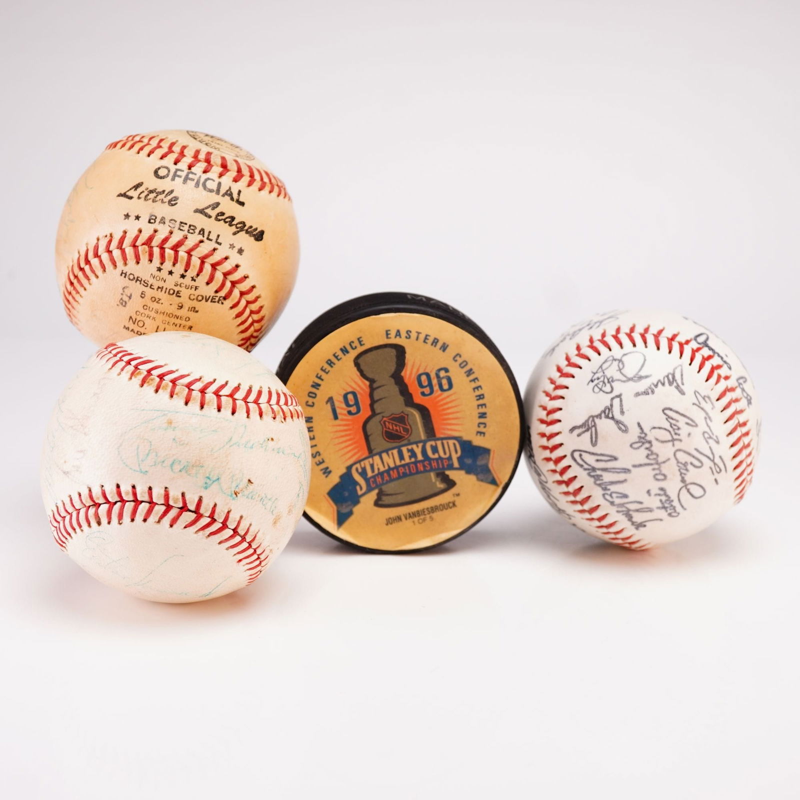 Sports Memorabilia Collection: Mickey Mantle Multi-Signed Baseball, 1997 Florida Marlins Team-Signed: This four-piece sports memorabilia collection features three multi-signed baseballs and one commemorative hockey puck. The highlight of the lot is a multi-signed baseball featuring the signature of Ne