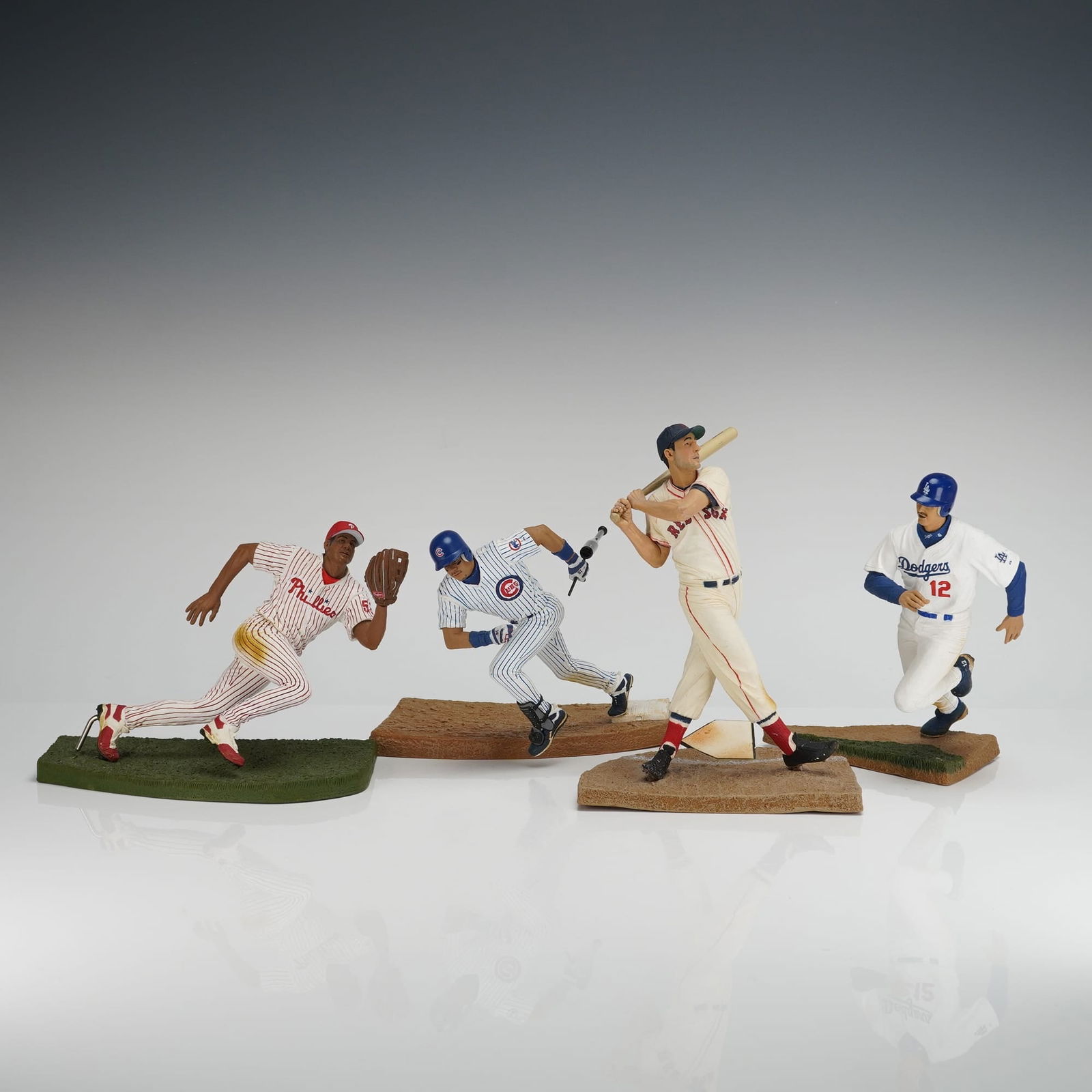 4pc TMP International Baseball Player Figurines: Four hand-painted plastic baseball action figurines produced by TMP International, dated 2006. The 4pc set depicts Major League Baseball players in action poses, mounted on scenic bases (two dirt/brow