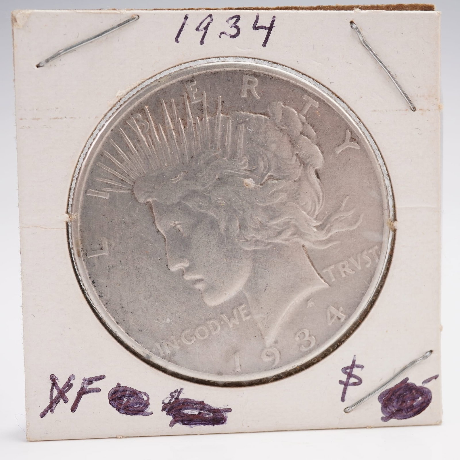 1934 Peace Silver Dollar: Composed of 90% silver and 10% copper with a total weight of 26.73 grams, this coin contains 0.999 troy ounces of pure silver. The obverse features the portrait of Liberty wearing a radiating crown wi