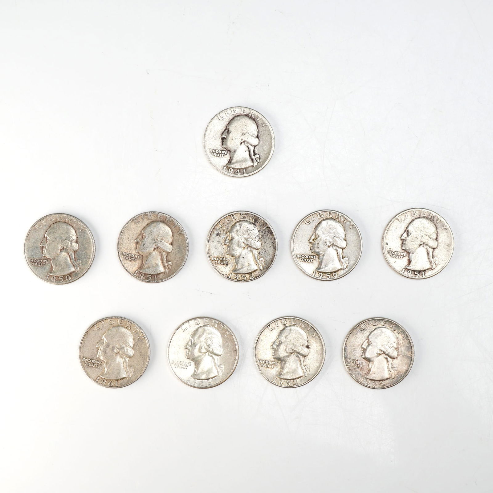1941,1950,1951,1958,1959,1961,1963,1964 Ten Washington Silver Quarter Circulated Coins: Minted by Philadelphia Mint. The obverse depicts a portrait of George Washington facing left, accompanied by the motto: "IN GOD WE TRUST" and surrounded with the lettering: "LIBERTY". The reverse depi