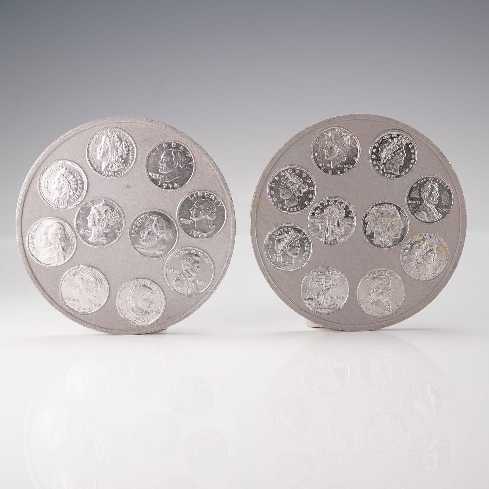 US Coins of the 20th Century Commemorative Medallion Set: A United States Coins of the 20th Century commemorative medallion set, consisting of two large round medallions featuring multiple miniature reproductions of classic 20th-century U.S. coin designs. Th