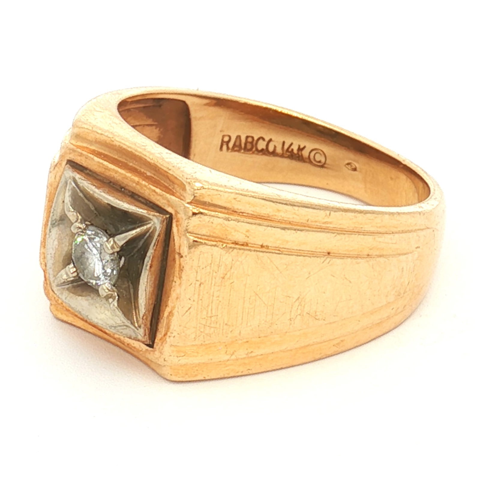 14K Rabco Two-Tone Gold Diamond Ring: Yellow gold ring with a wide square center top featuring stepped designs at the top and bottom of the band. A smaller white gold square is set on the top, holding a single round diamond at its