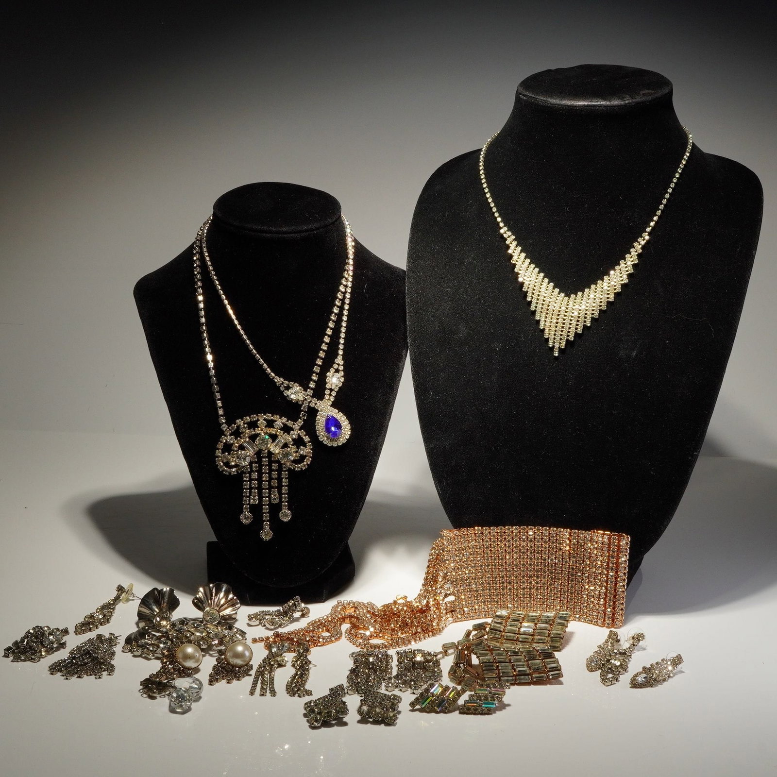 Assorted Silver-Tone and Gold-Tone Rhinestone Costume Jewelry Collection: This collection of vintage-style costume jewelry includes an assortment of necklaces and earrings. The pieces are primarily constructed from silver-tone and gold-tone base metals. The collection featu