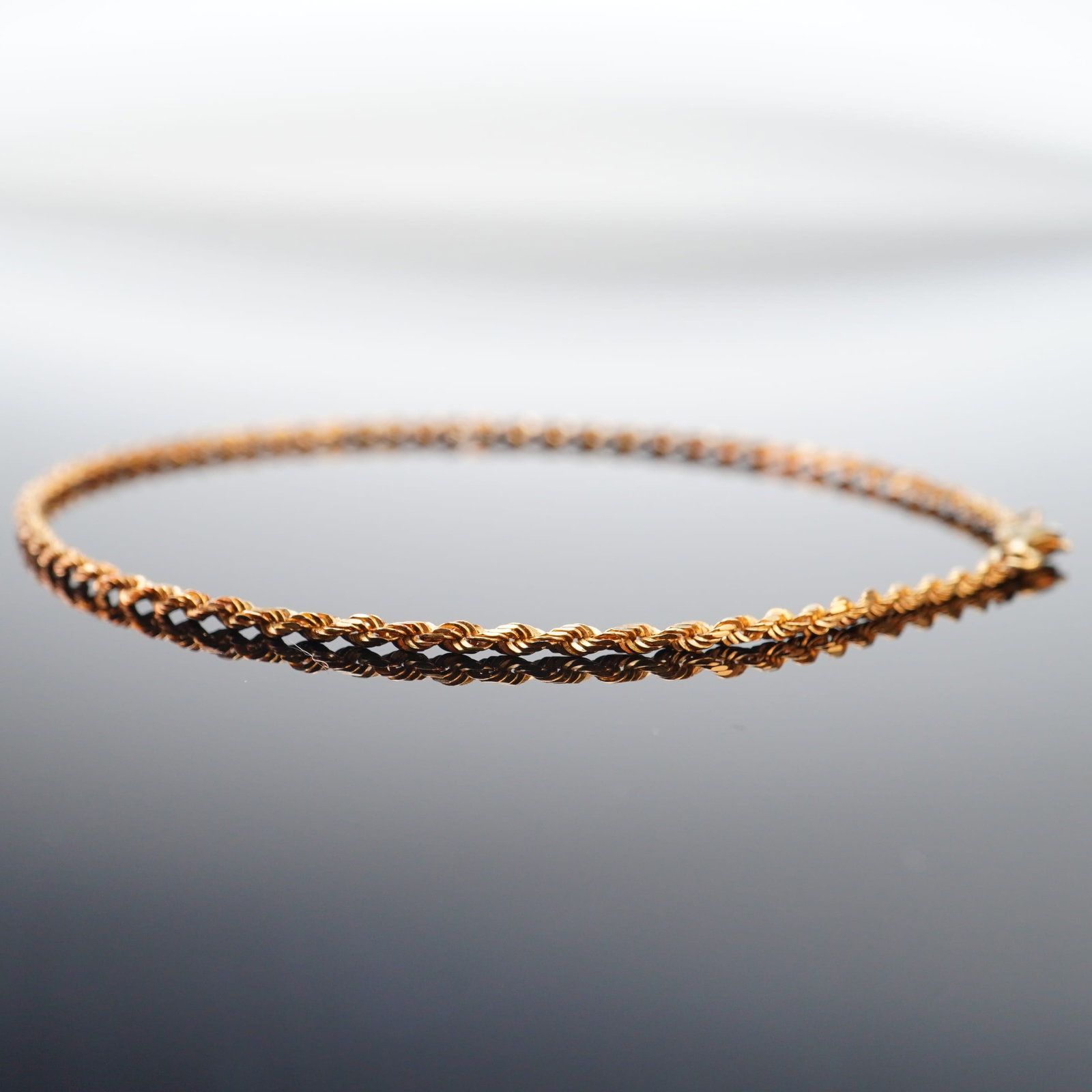 10K Yellow Gold Rope Chain Bracelet: Crafted from 10K yellow gold, this long chain bracelet features a twisted rope design. Marked 10K on the clasp. Dimensions9.5"L Weight2.78g