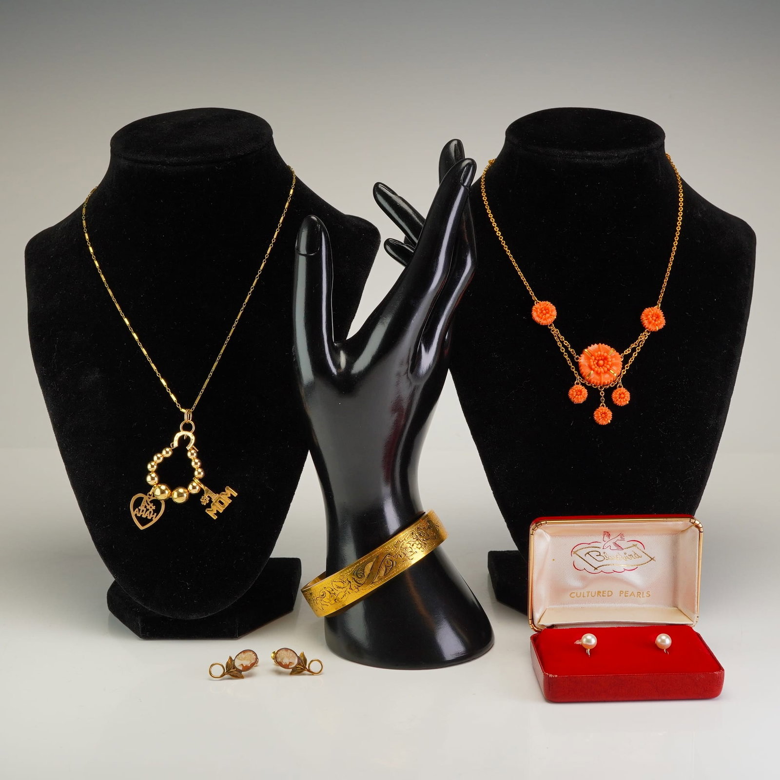 5pc 14K Gold and Gold-Filled Jewelry Collection with Cameo and Pearl Earrings: This five-piece jewelry collection features a variety of vintage and period pieces. One yellow metal necklace includes a pendant of polished spheres with two charms: a #1 MOM charm and a heart charm h