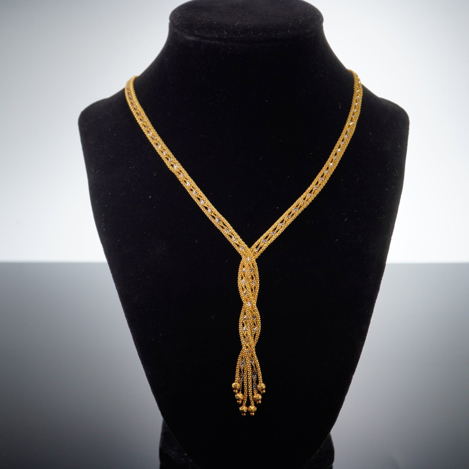 14K Yellow Gold Turkish Braided Tassel Necklace: Crafted from Turkish 14K yellow gold, this braided tassel necklace is accented by a central decorative knot and ends in gold bead tassels. Marked RL14K Turkey on clasp. Dimensions17.5"L Weight13g
