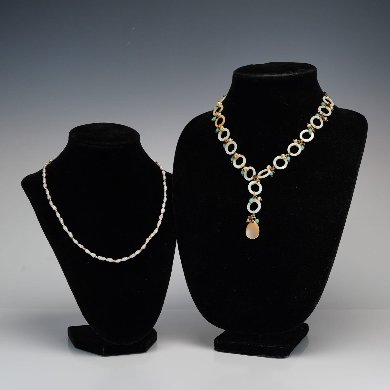 2pc Gold-Tone Rice Pearl and Mother-of-Pearl Ring Necklaces: This jewelry lot includes two distinct necklaces. The first is a single strand rice pearl necklace featuring white irregular pearls interspersed with small round gold-tone metal spacer beads and secur