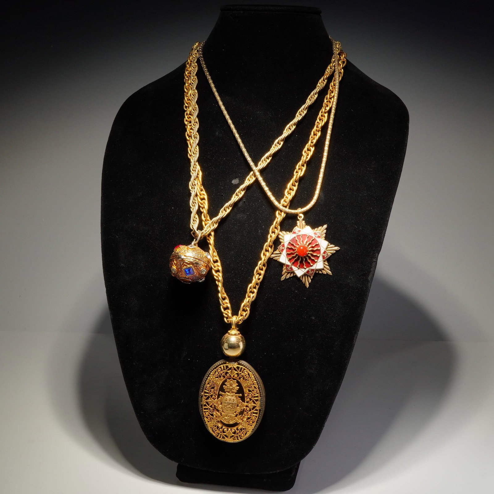 3pc Gold-Tone Statement Pendant Necklaces: This collection consists of three vintage gold-tone necklaces featuring large, ornate pendants. The first piece is a flat-link chain with a multi-pointed star pendant, decorated with red and white ena