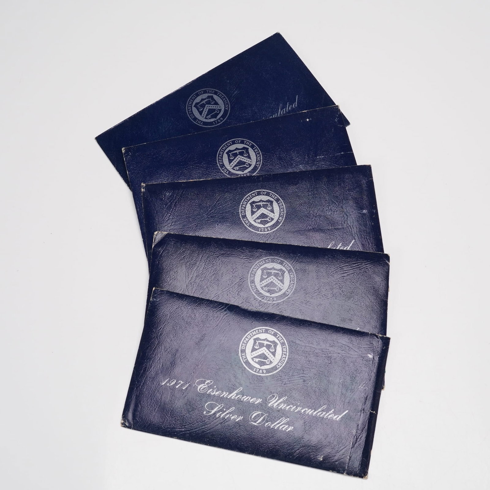 5pc 1971-S Eisenhower Uncirculated Silver Dollar Coin: This lot includes five 1971 Eisenhower Silver Dollar coins minted at the San Francisco Mint, each housed in its original blue government packaging. The set also includes five collection medallions. Th