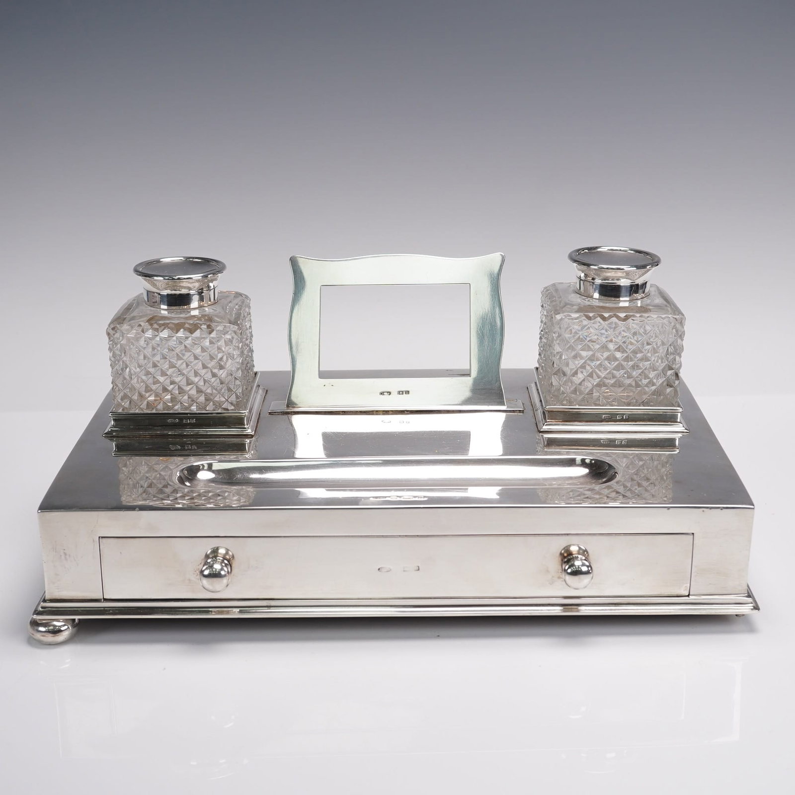 Victorian Silver Cut Glass Desk Inkwell by John Grinsell & Son. Birmingham: This Antique Sterling Silver Ink Stand, hallmarked in Birmingham in 1908 by John Grinsell & Sons Ltd., features a plain design with two cut glass pots for ink, a central section, and a drawer. The hal