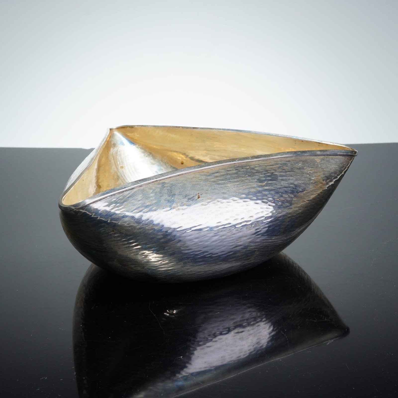 Argenta Sterling Silver Hammered Triangle Bowl: Bowl features a distinctive triangular tricorn form. The vessel is constructed with a hammered exterior texture and a smooth interior. The base is stamped with the hallmark ARGENTA 0.925, indicating i