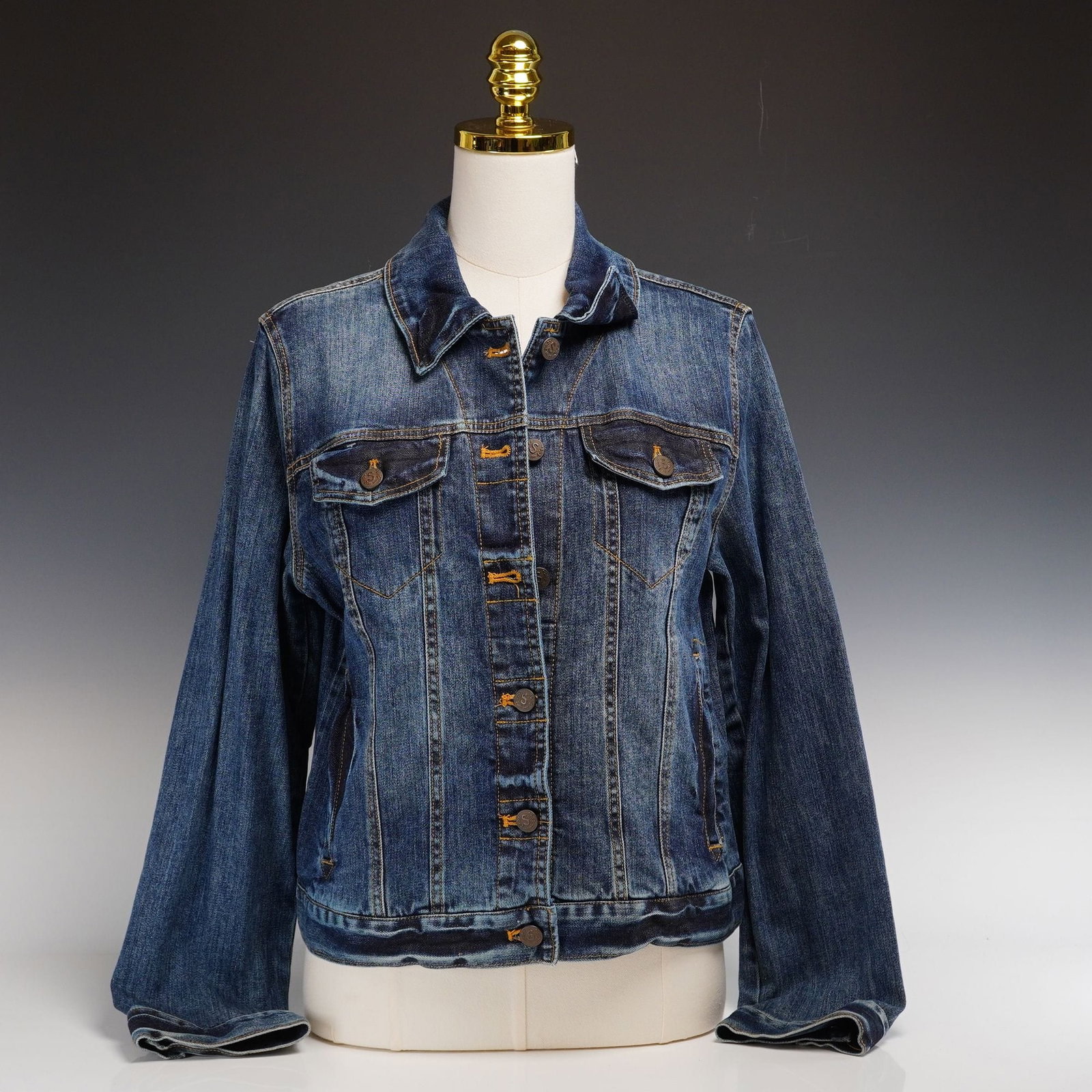 Contemporary Sundance Desert Haze Denim Jacket with Southwestern Embroidered Back Panel: This contemporary Sundance Desert Haze denim trucker jacket, size M, is crafted from medium-wash blue cotton denim with factory-distressed detailing. The jacket features a classic pointed collar, two