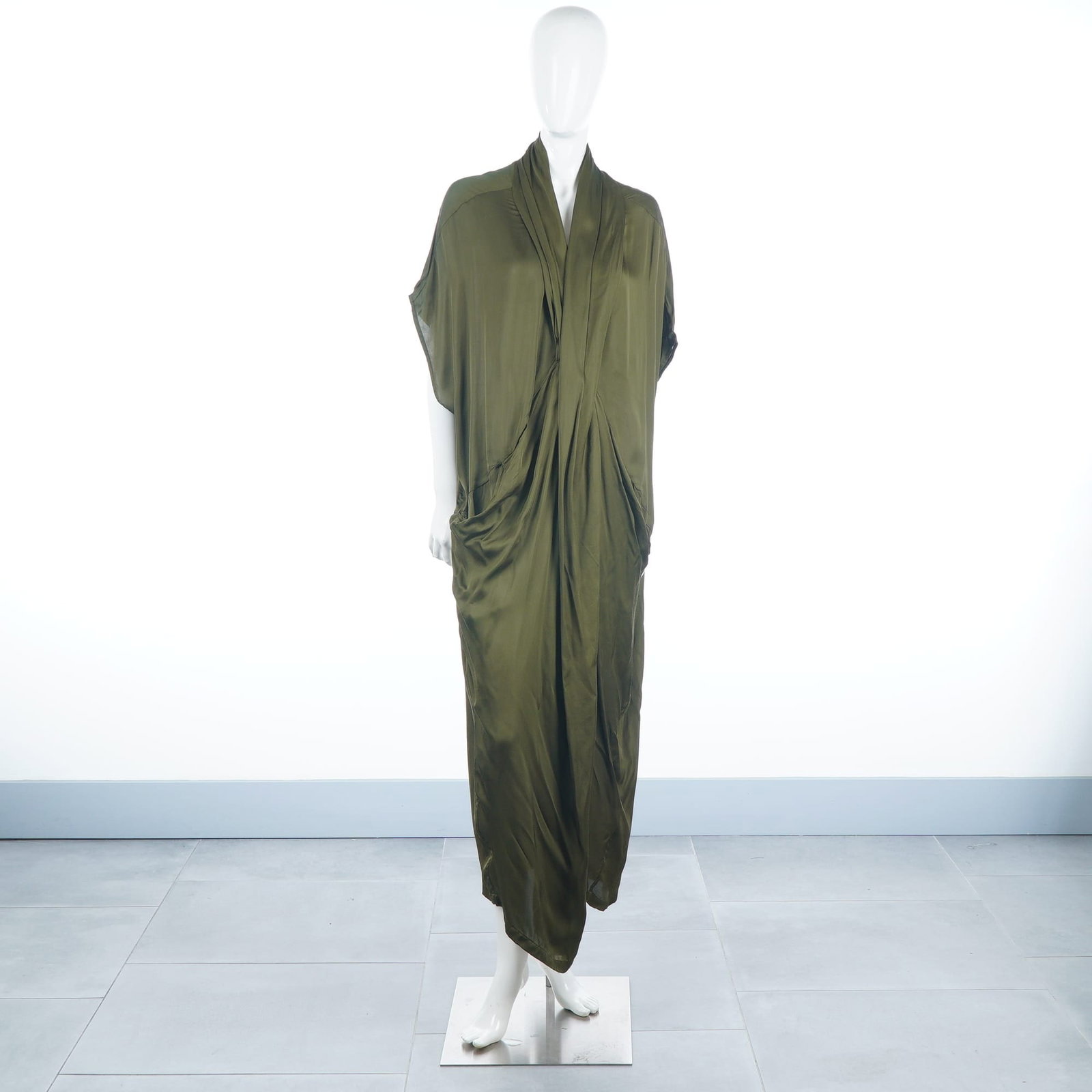 Nicholas K Malta Military Olive Green Asymmetrical Maxi Dress: This Nicholas K Malta dress is crafted from a fluid fabric with a subtle sheen in the brand's signature Military olive green. The garment features a deep V-neckline and short kimono-style sleeves, tra