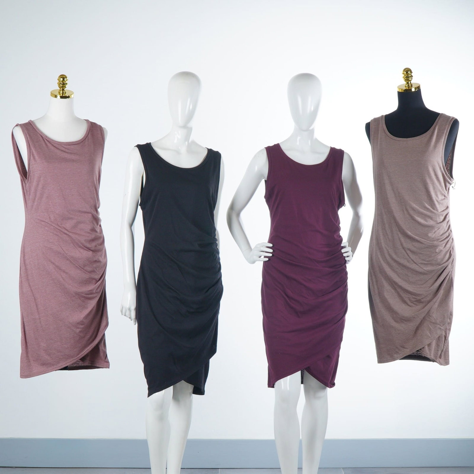 4pc Leith Sleeveless Ruched Bodycon Midi Dresses: This lot by Leith features four sleeveless bodycon midi dresses characterized by a scoop neckline and an asymmetrical tulip-style wrap hem with side ruching. The garments are crafted from a lightweigh