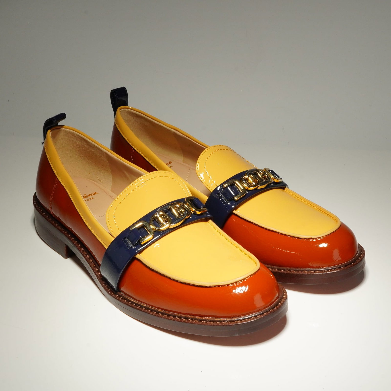 Sam Edelman Women's Patent Leather Loafers, Christy: Sam Edelman Christy loafers featuring a color-blocked patent leather construction in copper, yellow, and navy blue. The design includes a rounded toe and a low block heel, accented by gold-tone interl