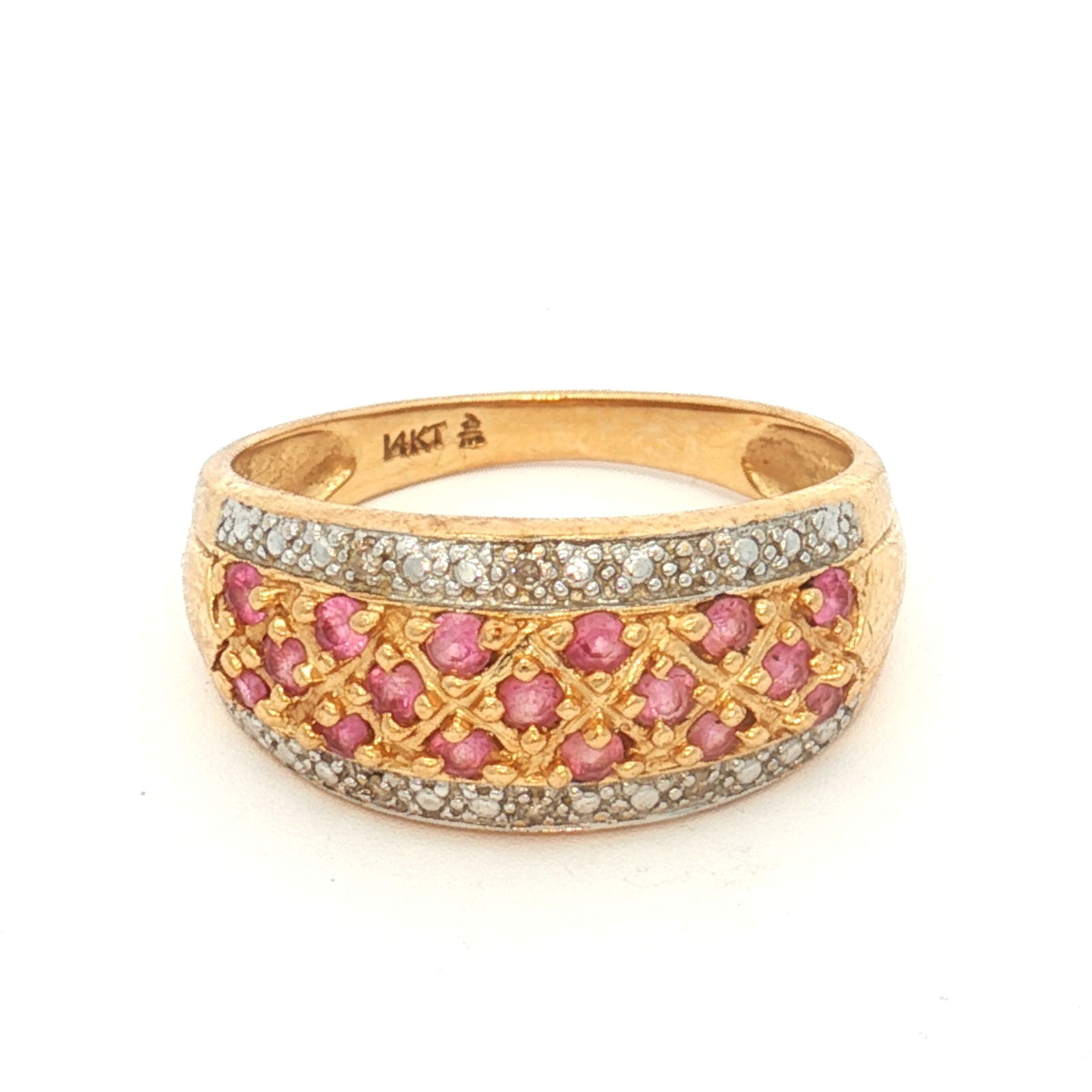 14K Yellow Gold Pink Sapphire and Diamond Ring: Yellow gold ring featuring a slightly domed center set with round pink sapphires. Round diamonds are set along the top and bottom edges of the sapphire section. Inner band is marked 14KT. DimensionsRi