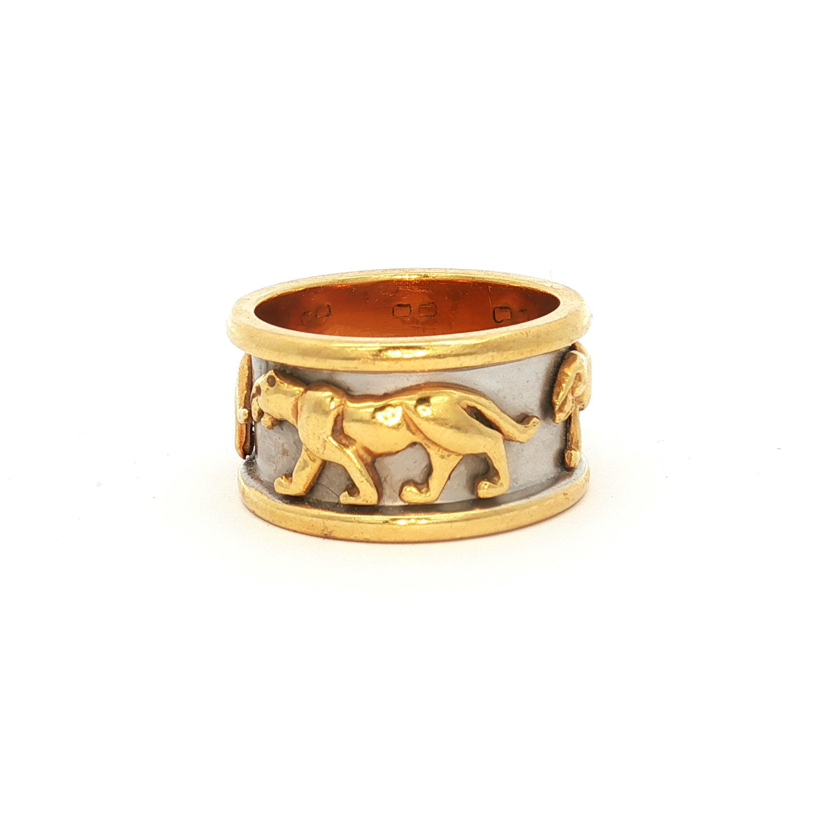 18K Two-Tone Gold Walking Panther Band Ring: A wide band ring crafted from 18K yellow and white gold, featuring walking panthers that wrap around the band. Tested with Thermo Scientific Niton XL2 XRF Precious Metal Analyzer. DimensionsRing size: