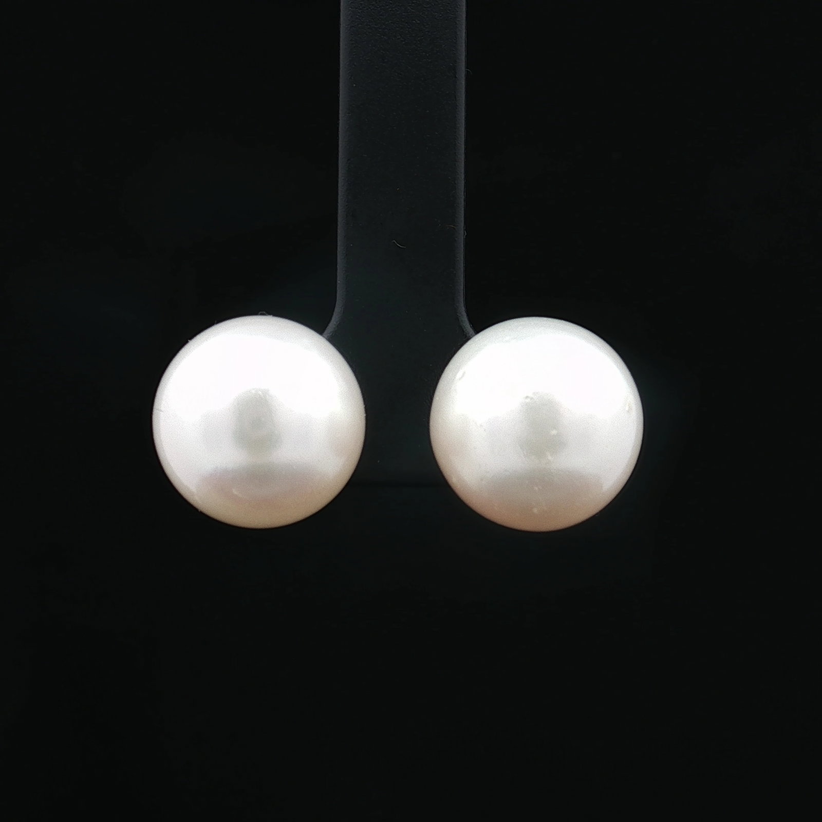 14K White Gold Pearl Stud Earrings: A pair of stud earrings featuring round pearls with white gold posts and backs, both marked 14K. Measurement is for each item. Dimensions0.5"W Weight7.1g