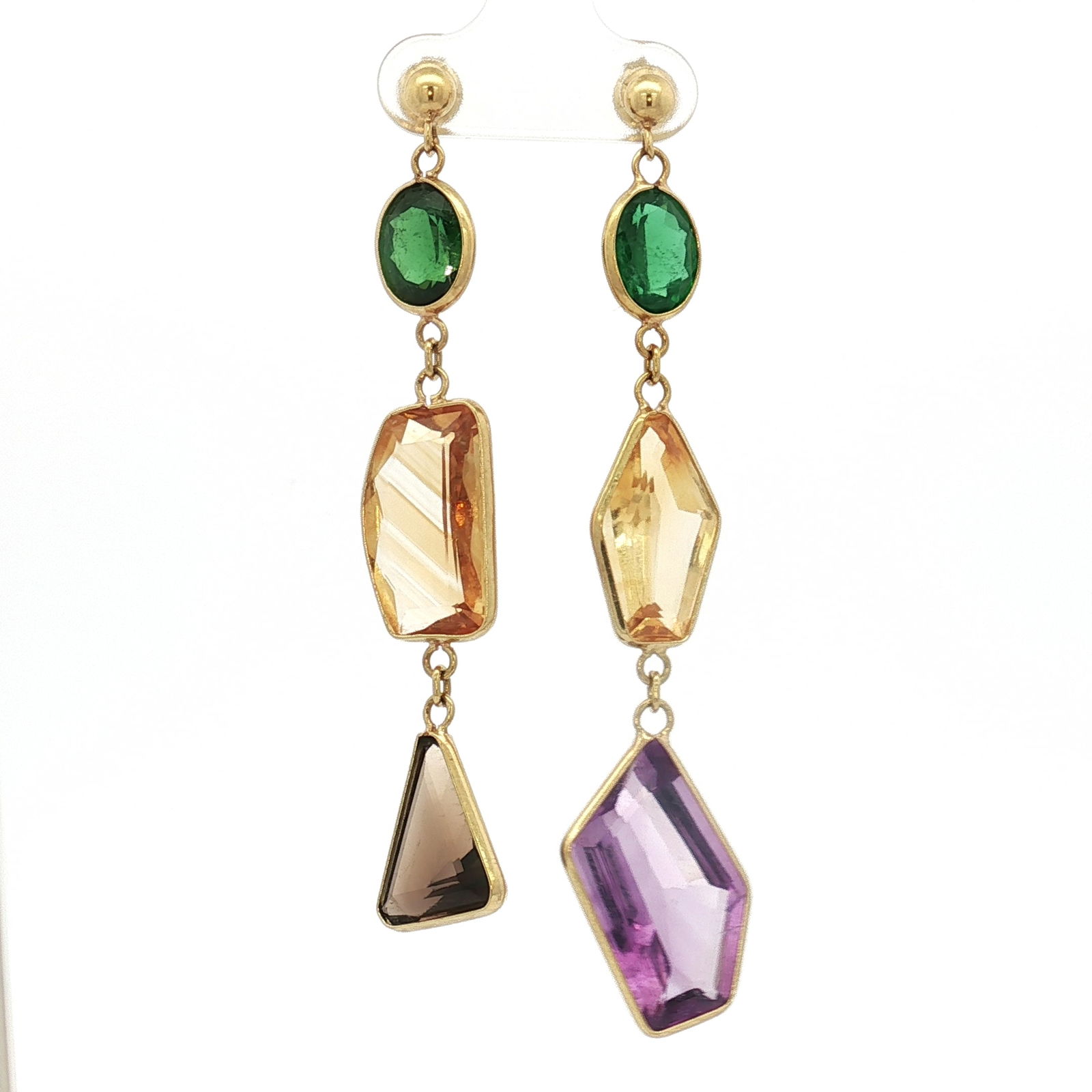 18K Multi Gemstone Dangle Earrings: A pair of yellow gold dangling earrings featuring a mix of green tourmaline, citrine, amethyst, and smoky quartz, each gemstone presented in various shapes and cuts. The backings are marked 750. Dimen