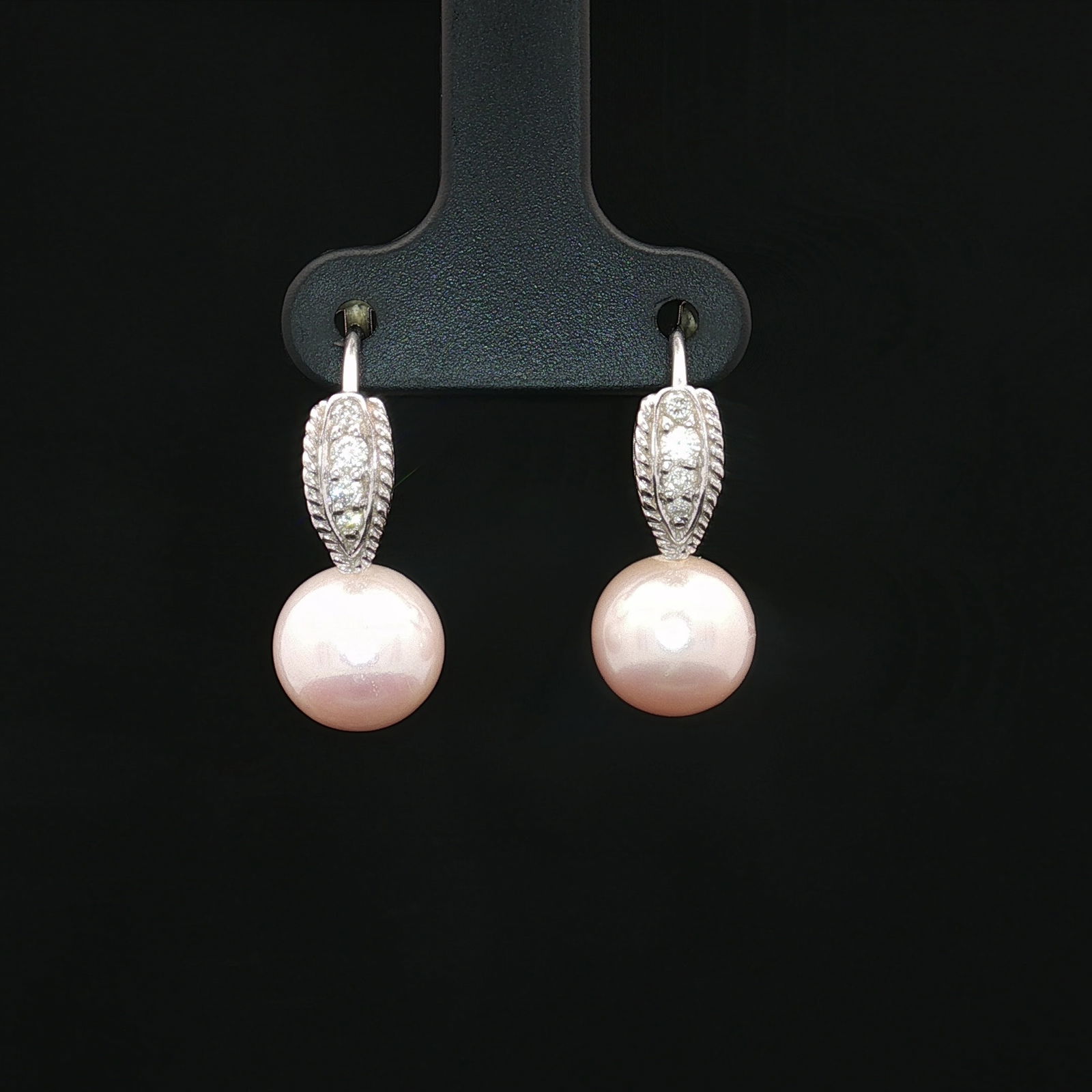 18K White Gold Diamond and Pearl Leverback Earrings: A pair of white gold leverback earrings set with four diamonds each, ending with a pearl. The leverbacks are stamped 750. Tested with Presidium Gem Tester II. Measurement is for each item. 