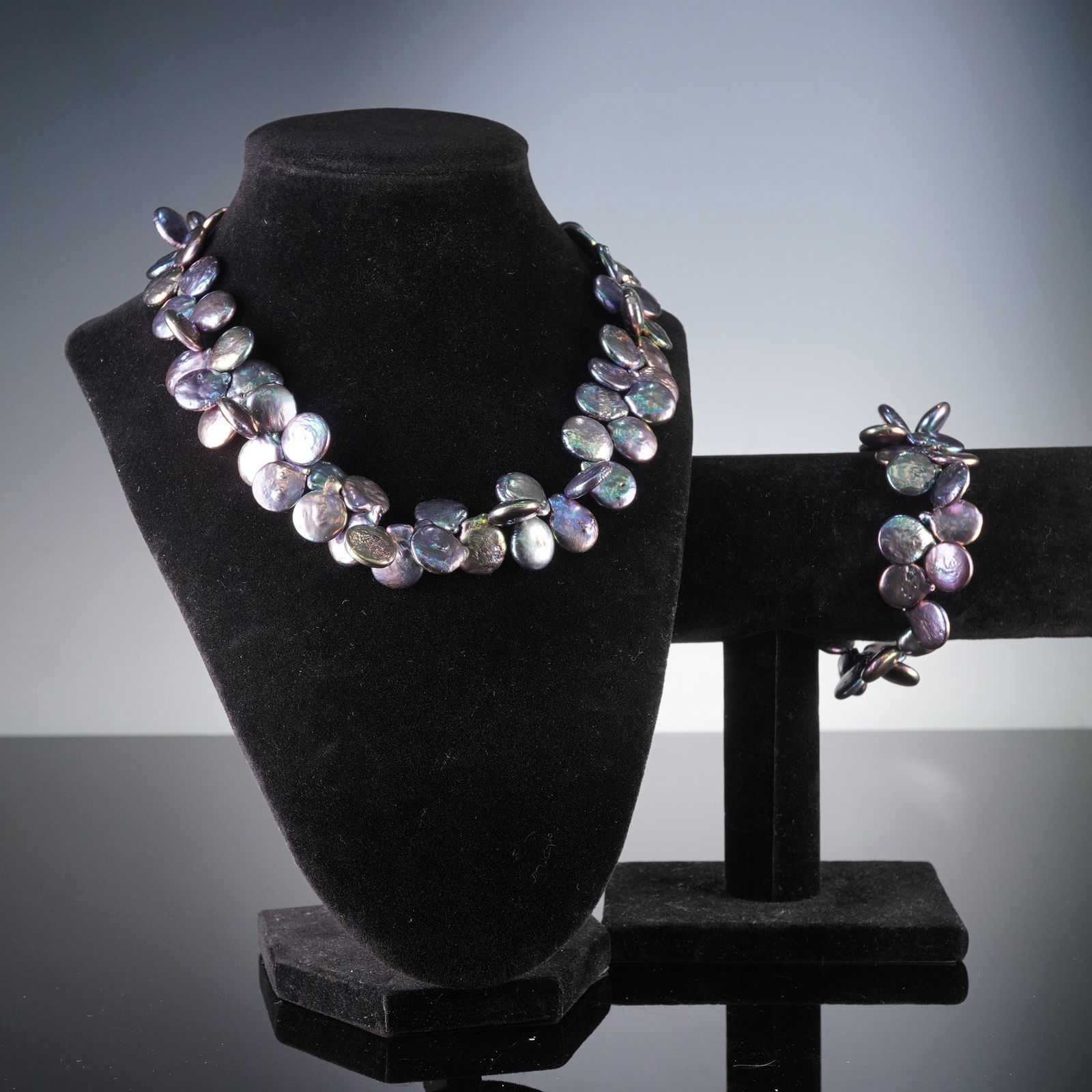 2pc Set of Iridescent Peacock Keshi and Coin Pearl Necklace w/ 14K Gold Clasp: A matched set of iridescent peacock keshi and coin pearls, comprising a necklace and a bracelet, from Nassau Bahamas. Each piece is crafted from numerous irregularly shaped, flat pearls displaying a v