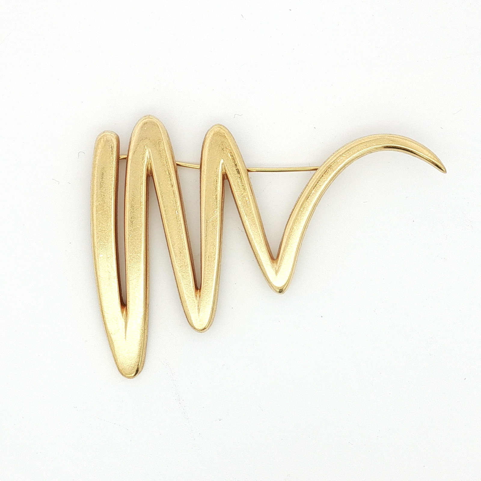 Tiffany & Co. Paloma Picasso 18K Gold Zig Zag Brooch: A yellow gold brooch designed as a zig zag scribble. The reverse is marked 1983, Tiffany & Co, 18K, and has the stamped signature of Paloma Picasso. Dimensions2.75"L x 2"W Date or Era1983 Manufacturer