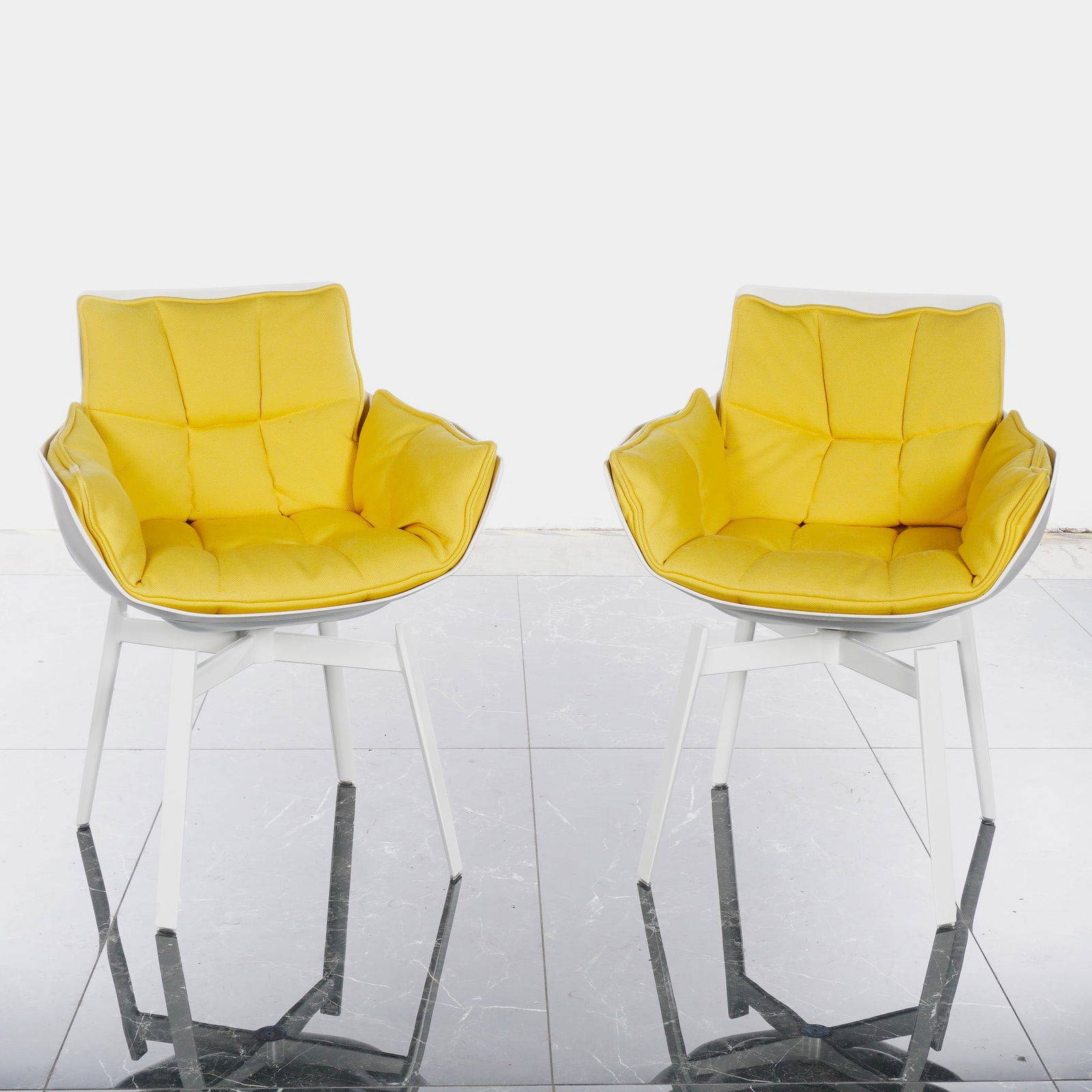 Pair of B&B Italia Husk White Swivel Armchairs by Patricia Urquiola: A pair of contemporary B&B Italia Husk white swivel chairs with yellow fabric seats designed by Patricia Urquiola. Each chair features a white, recycled plastic molded shell with a distinctive capiton