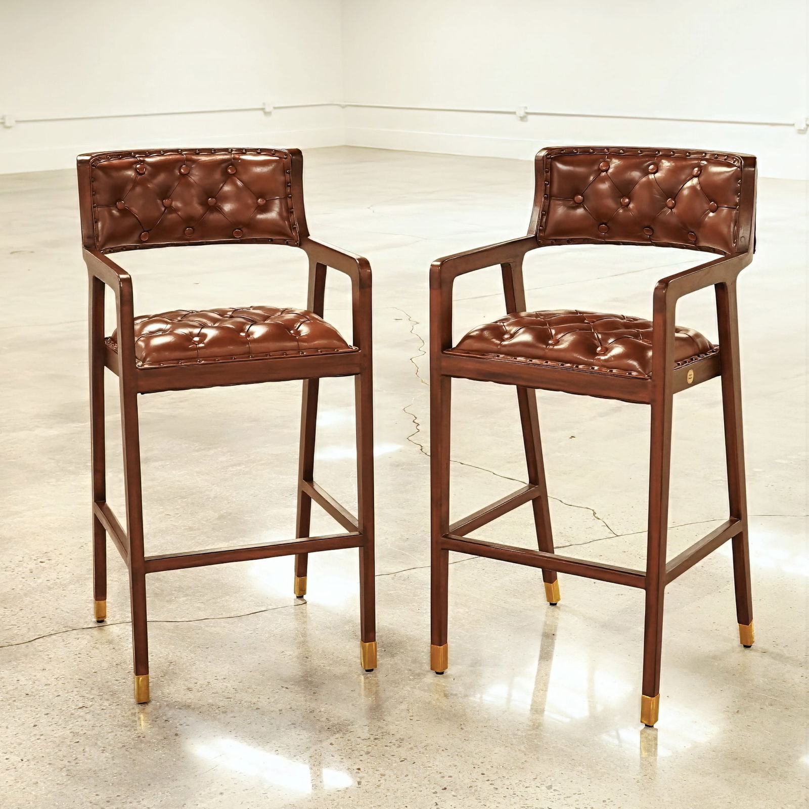 Pair of Olivier De Schrijver Bar Chairs in Teak Wood, Brighton: A pair of Olivier De Schrijver bar chairs designed in a Chesterfield style and titled "Brighton." The frames are constructed from brown stained teak wood and upholstered in brown button-tufted leather