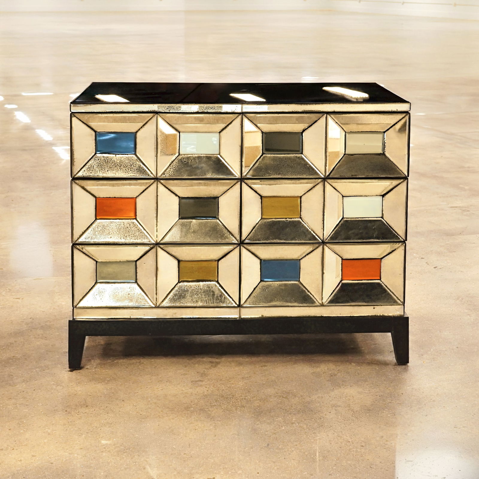 Olivier de Schrijver Mirrored Cabinet with Black Painted Feet, Texas: This Olivier de Schrijver mirrored cabinet, the Texas model, features a facade of twelve beveled, pyramidal mirrored panels. These panels are accented with colorful glass insets in shades of blue, ora