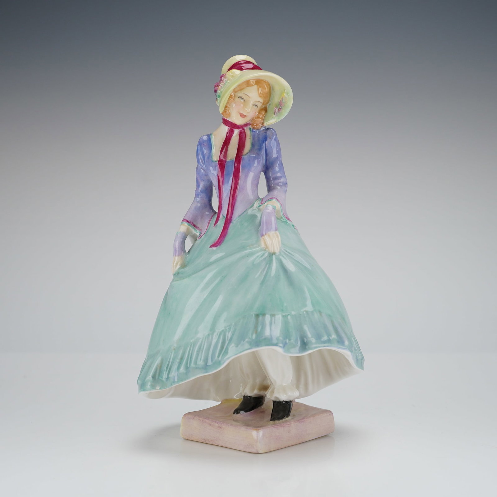Royal Doulton Figurine Pantalettes HN1362: A single glazed porcelain figurine identified as Royal Doulton model HN1362, titled "Pantalettes." The figure depicts a woman in 19th-century inspired dress, featuring a wide-brimmed bonnet secured wi